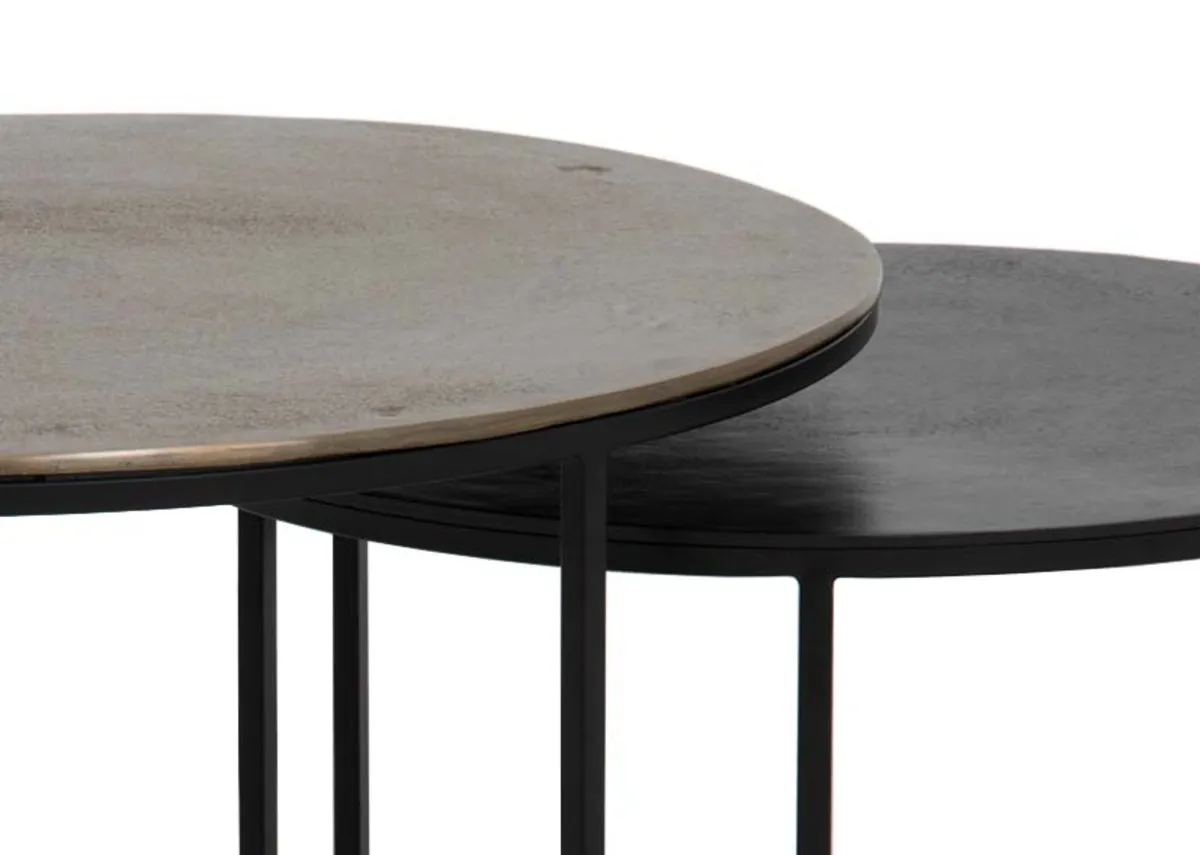A nest of 2 black and brass coffee tables from EZ Living Furnitures Kersen rannge. Closeup of antique brass texture.