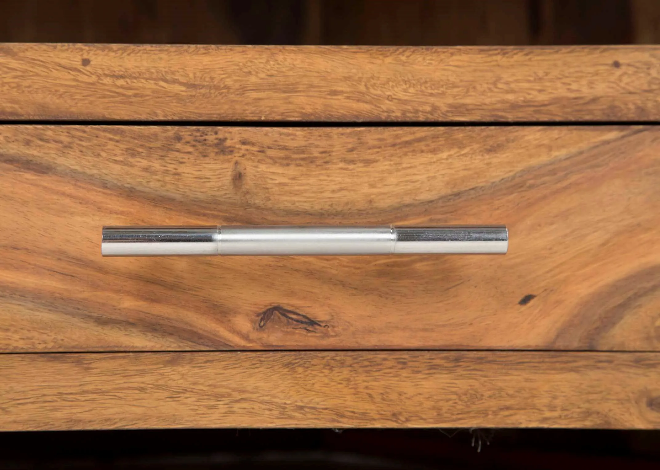 Detailed view of front of drawer of two-drawer sheesham wood TV corner unit India