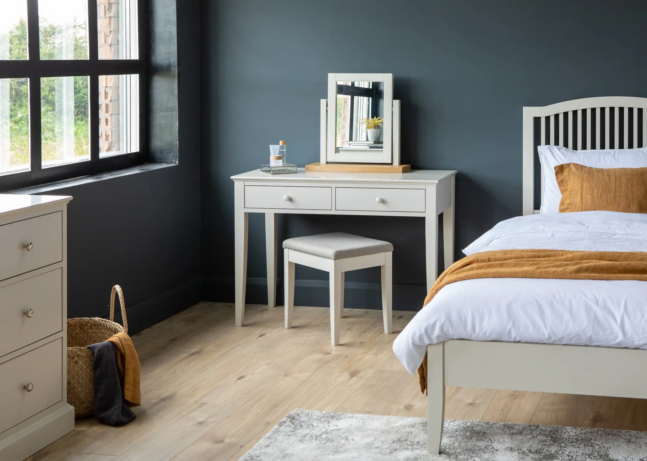 A lifestyle image of the grey vanity dresser & stool with bedframe from EZ Living Furniture