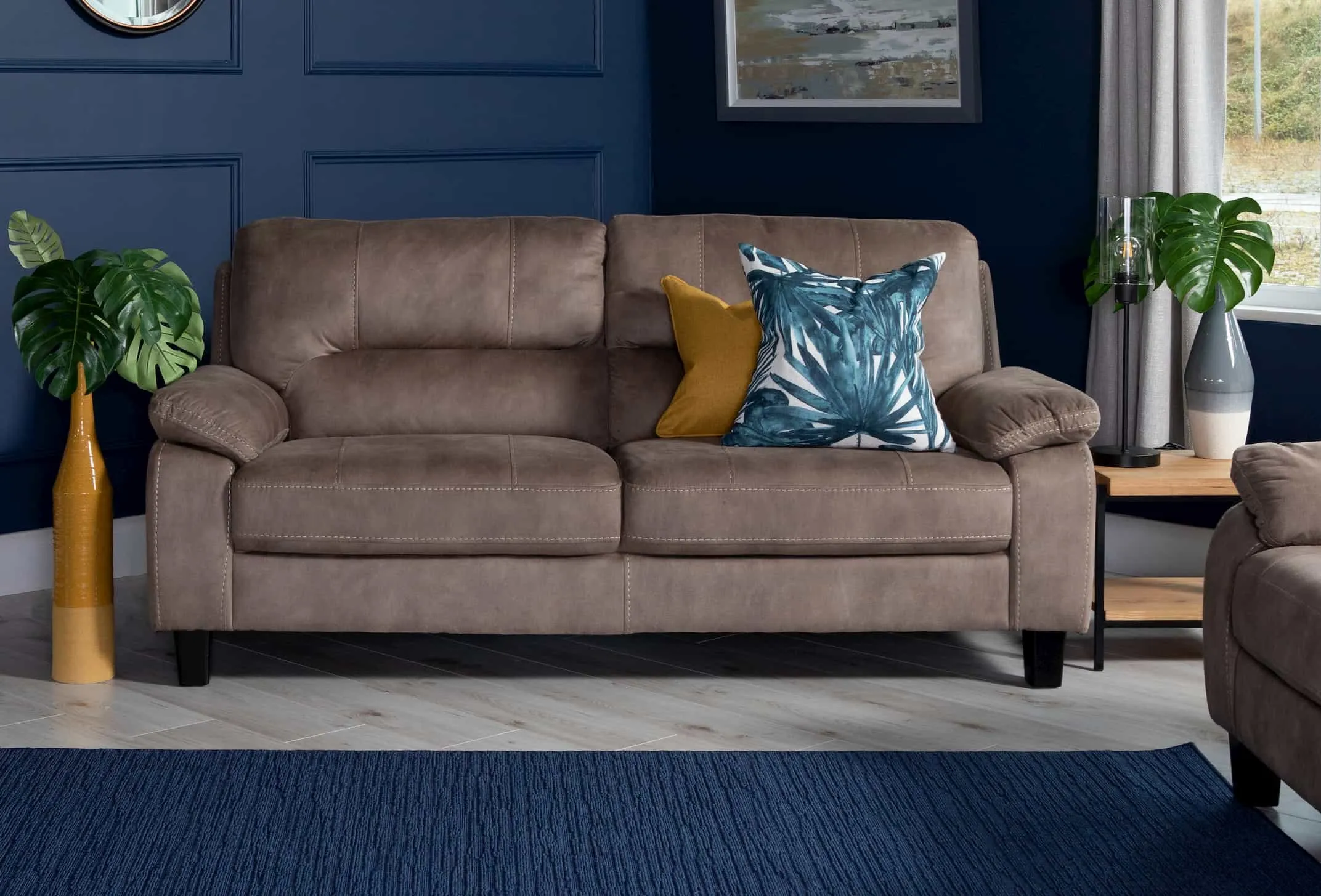 A lifestyle image of the 2 seater brown fabric Nikita sofa