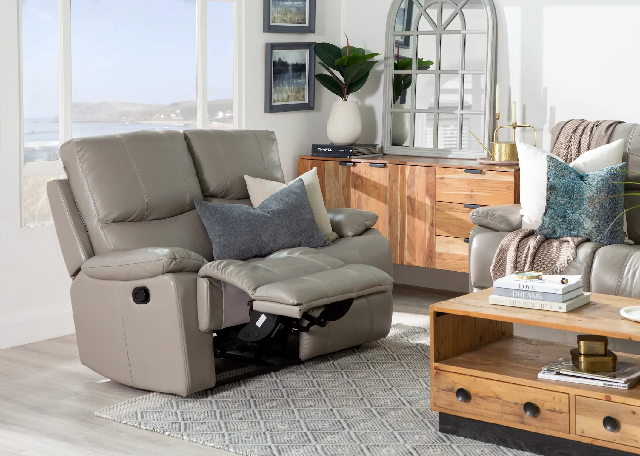 A lifestyle image of the 2 seater Groove grey leather recliner with San Fran living in power recline mode.