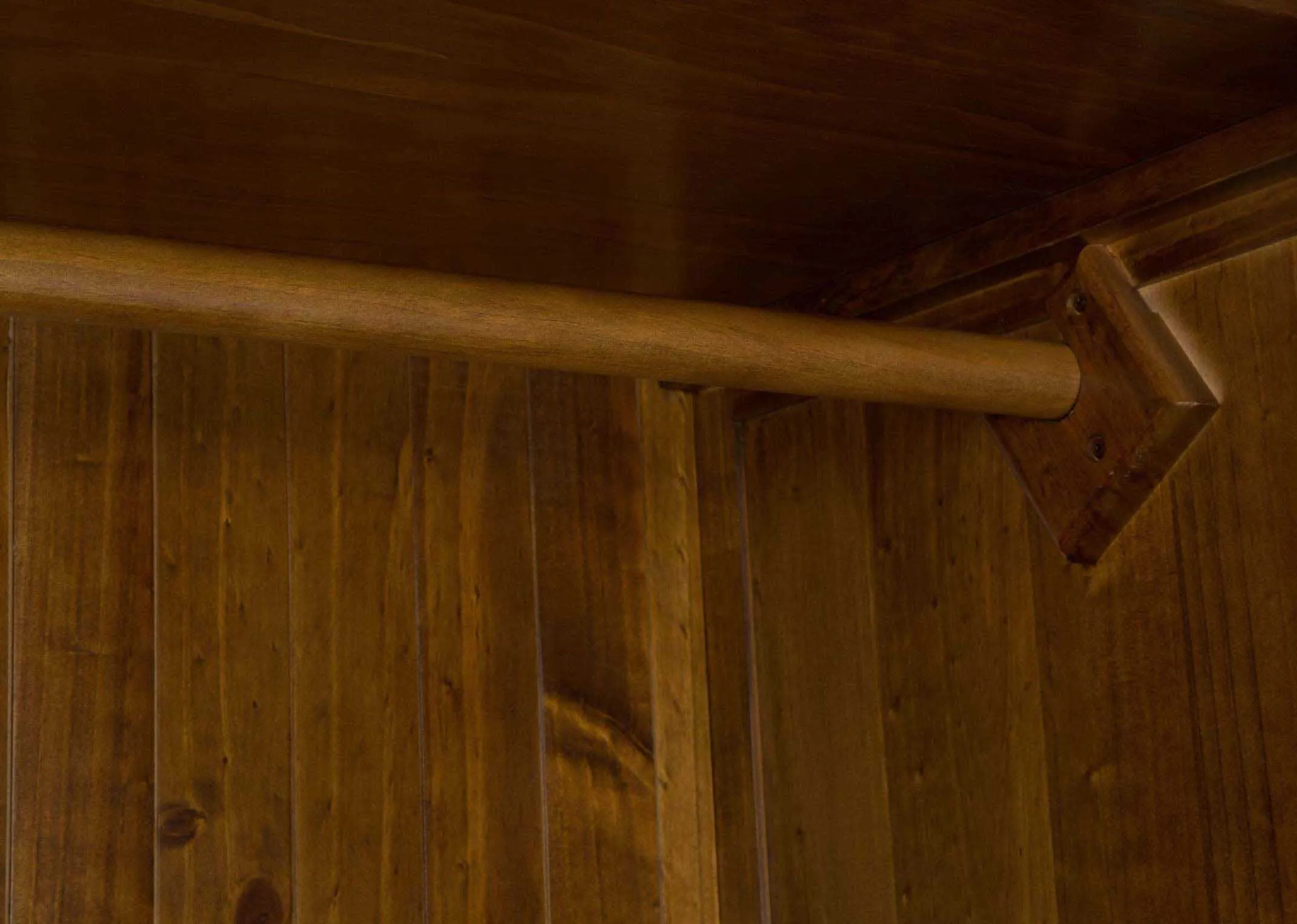 Detailed view of interior of solid dark gloss wood two-door two-drawer wardrobe Aisling