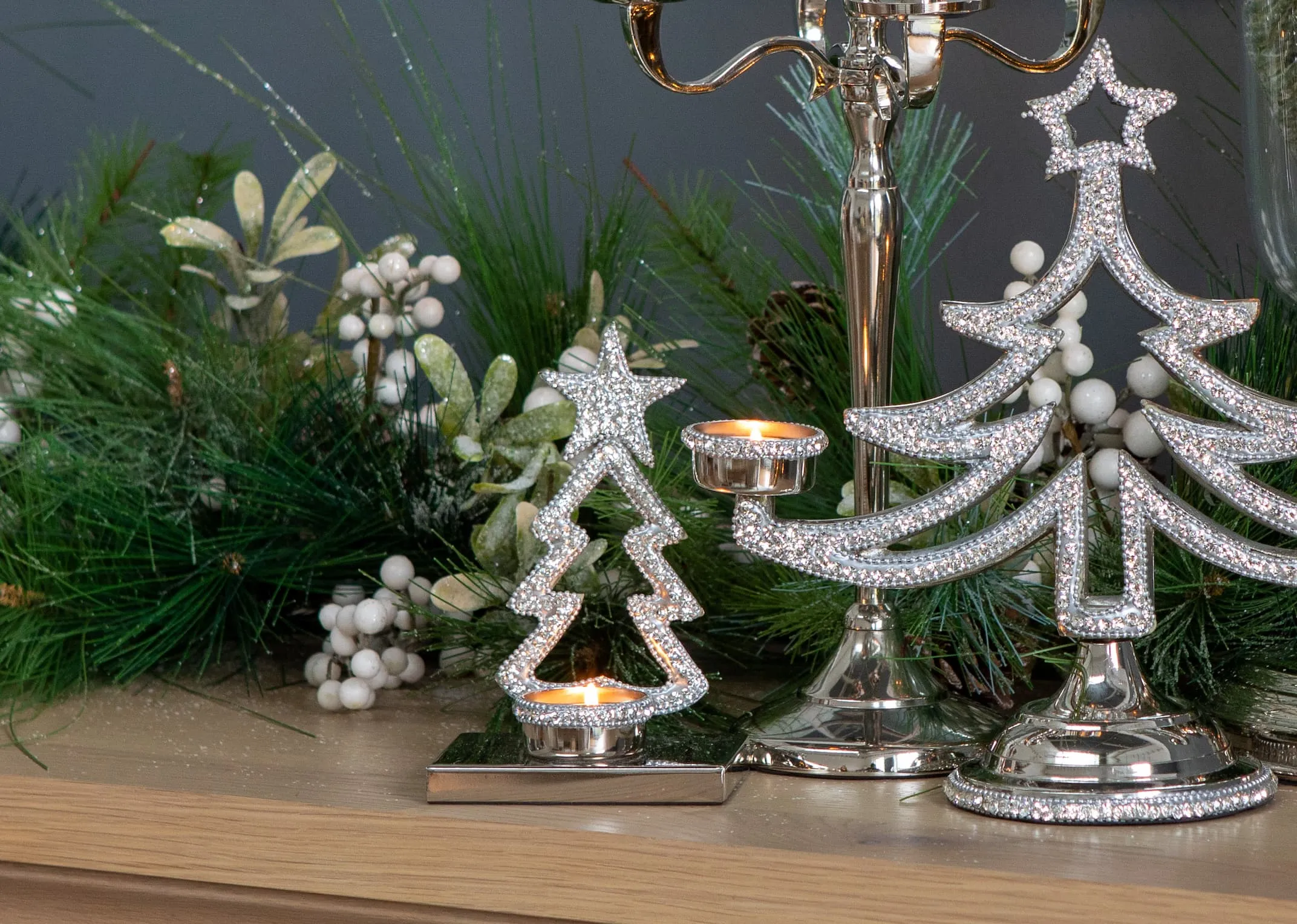 A lifestyle image of the Rhinestone Xmas tree candles holders on the Athens Console table