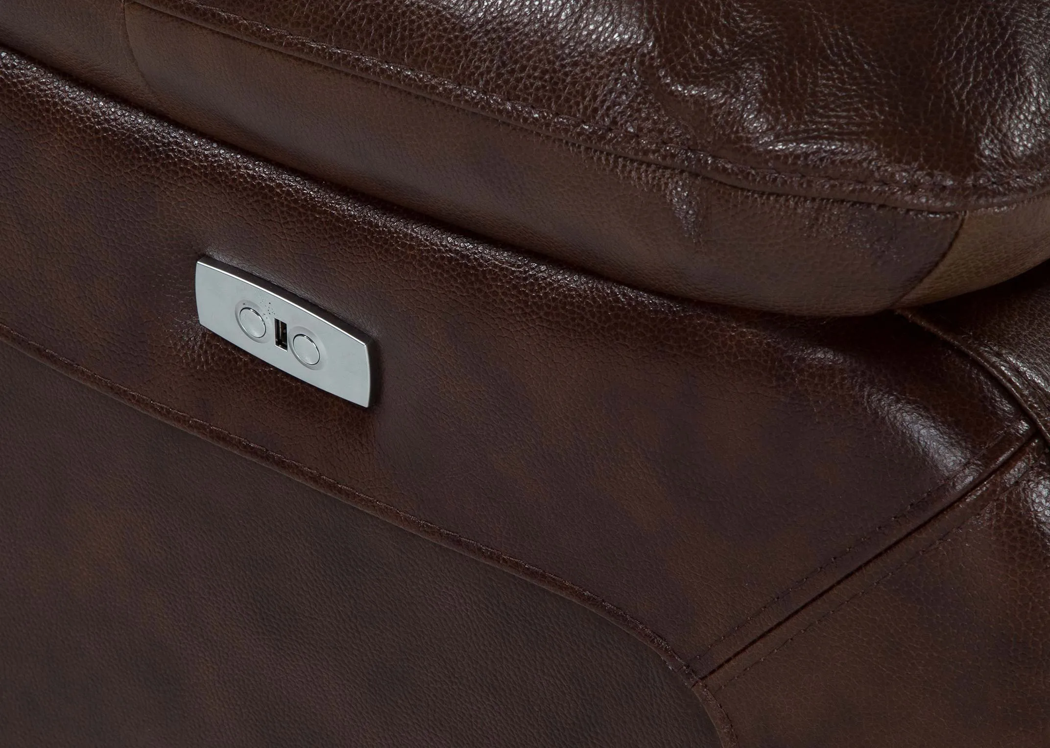 A close up of the reclining button on the SUPREME 3 seater power recliner.