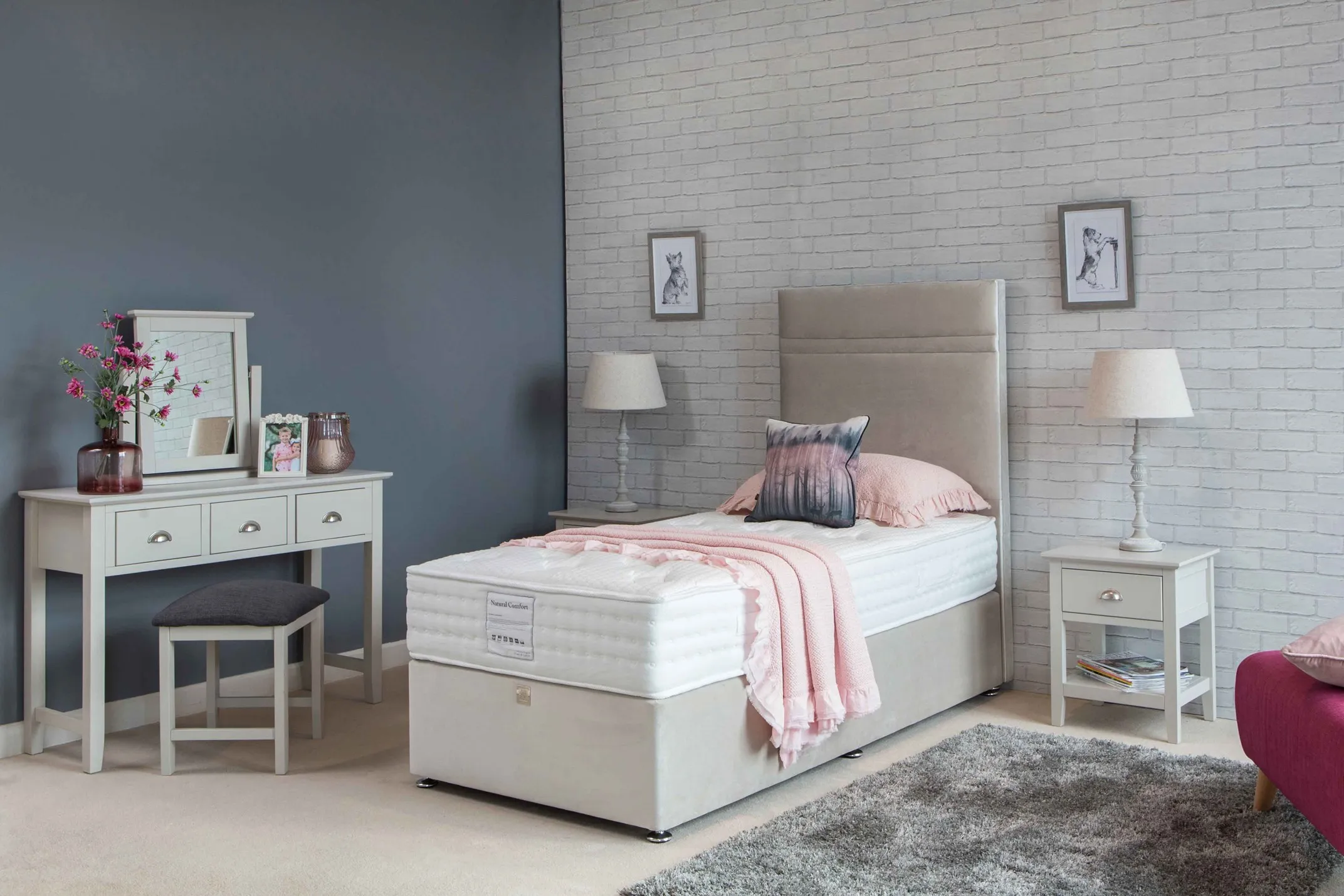 A lifestyle image for the Natural Comfort mattress in a bedroom setting with salmon pillow case and throw.