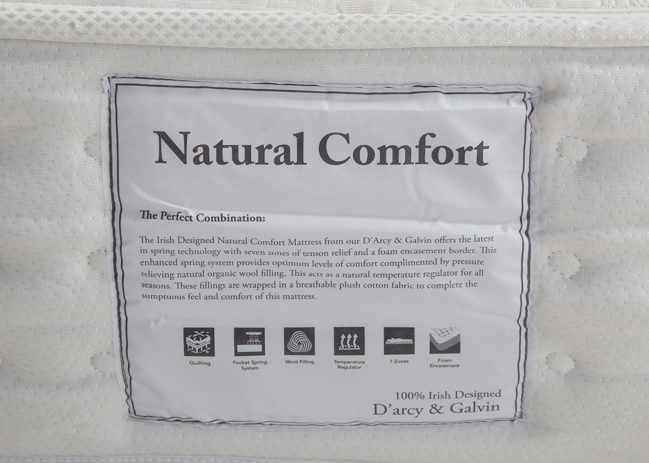 A close up of the tag on the Natural Comfort roll up mattress with various details shown.