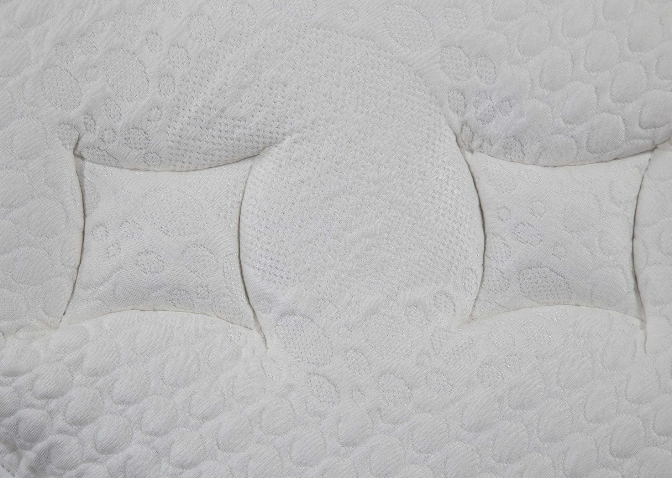 A close up of the micro quilted material on the 4 ft 6 Natural Comfort pocket sprung roll up mattress