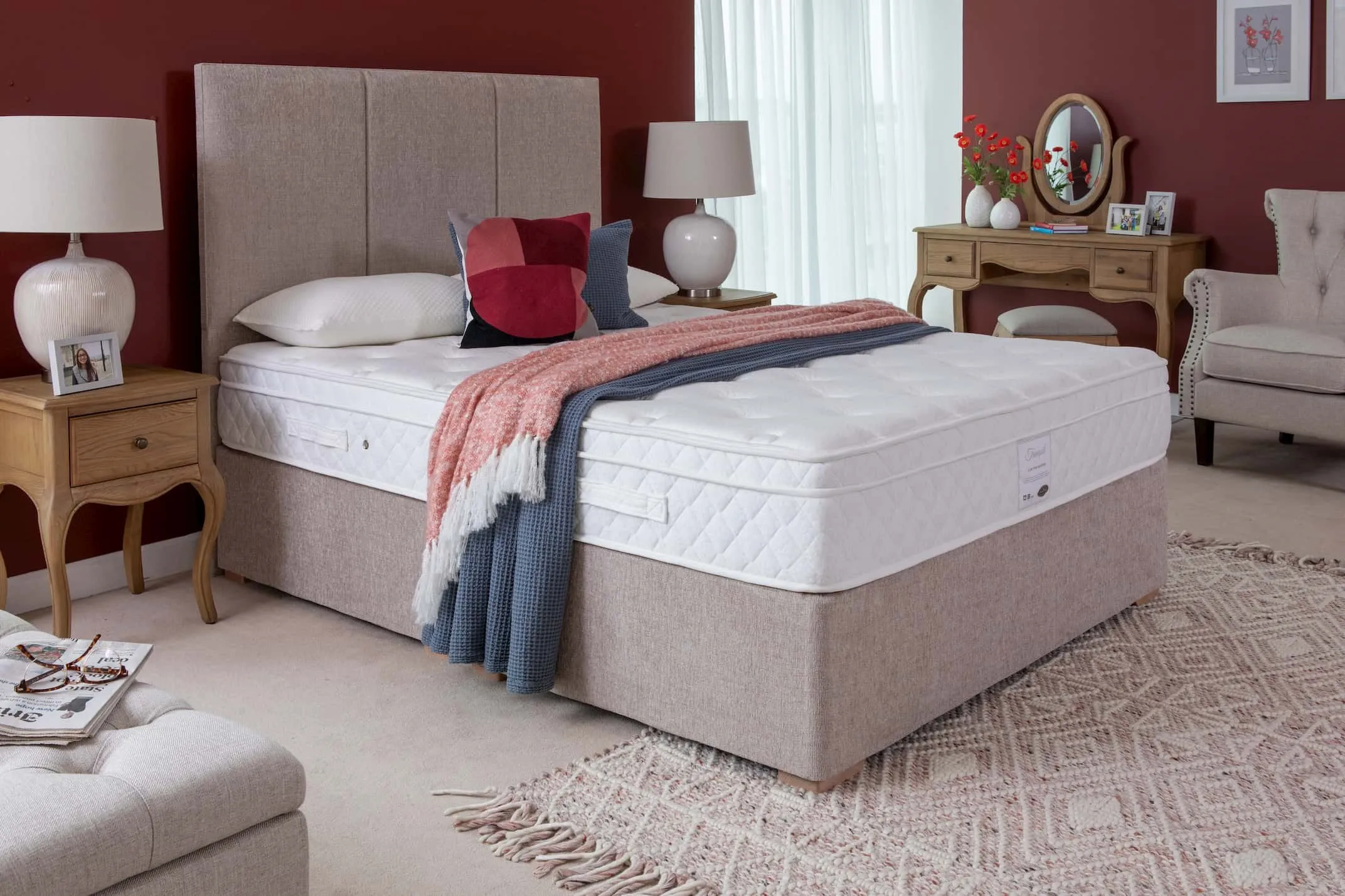 A lifestyle image of the Tranquil mattress with french oak bedroom furniture.