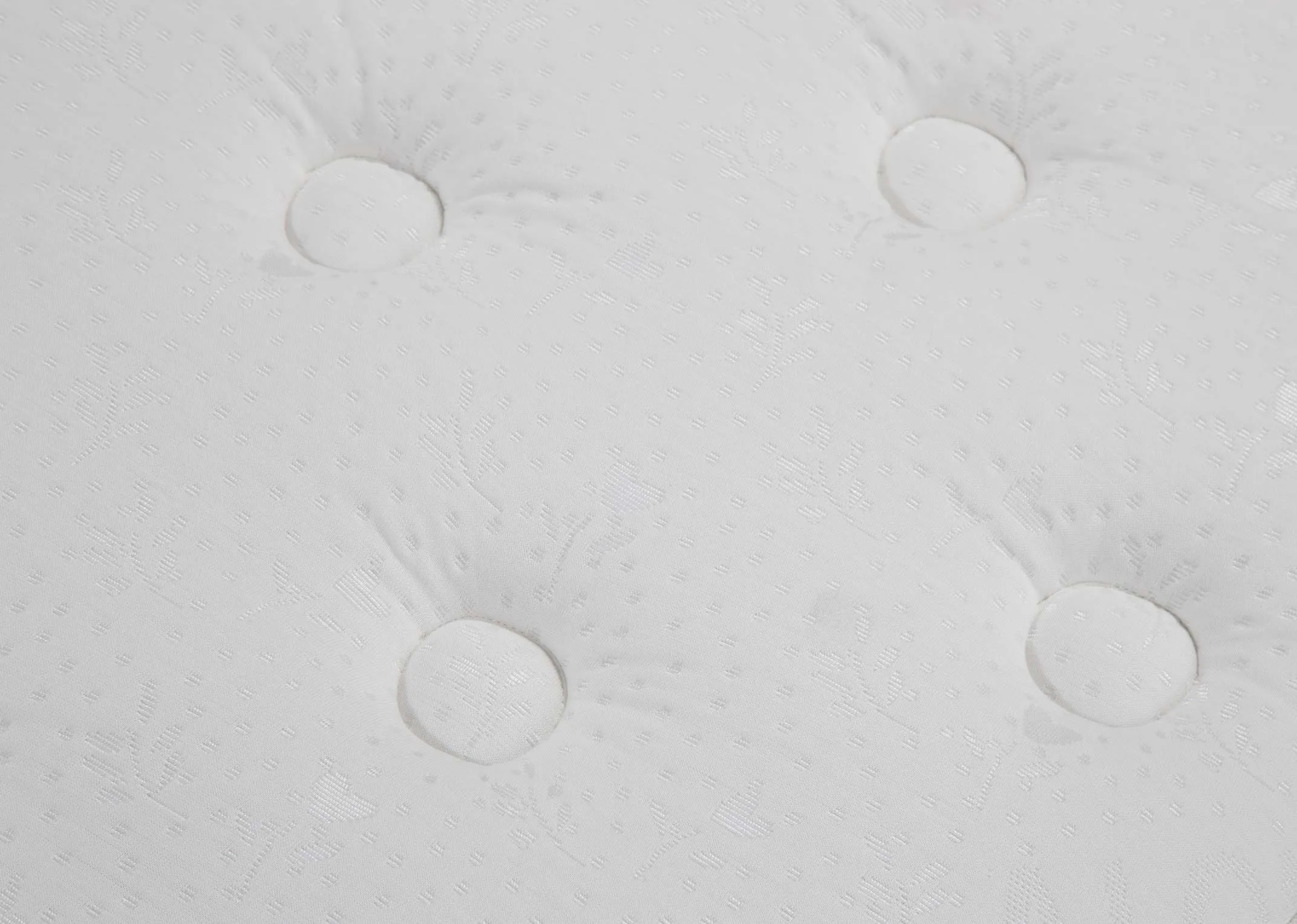 A close up of the surface on the Tranquil 4 ft mattress highlighting the circular pattern on the fabric.