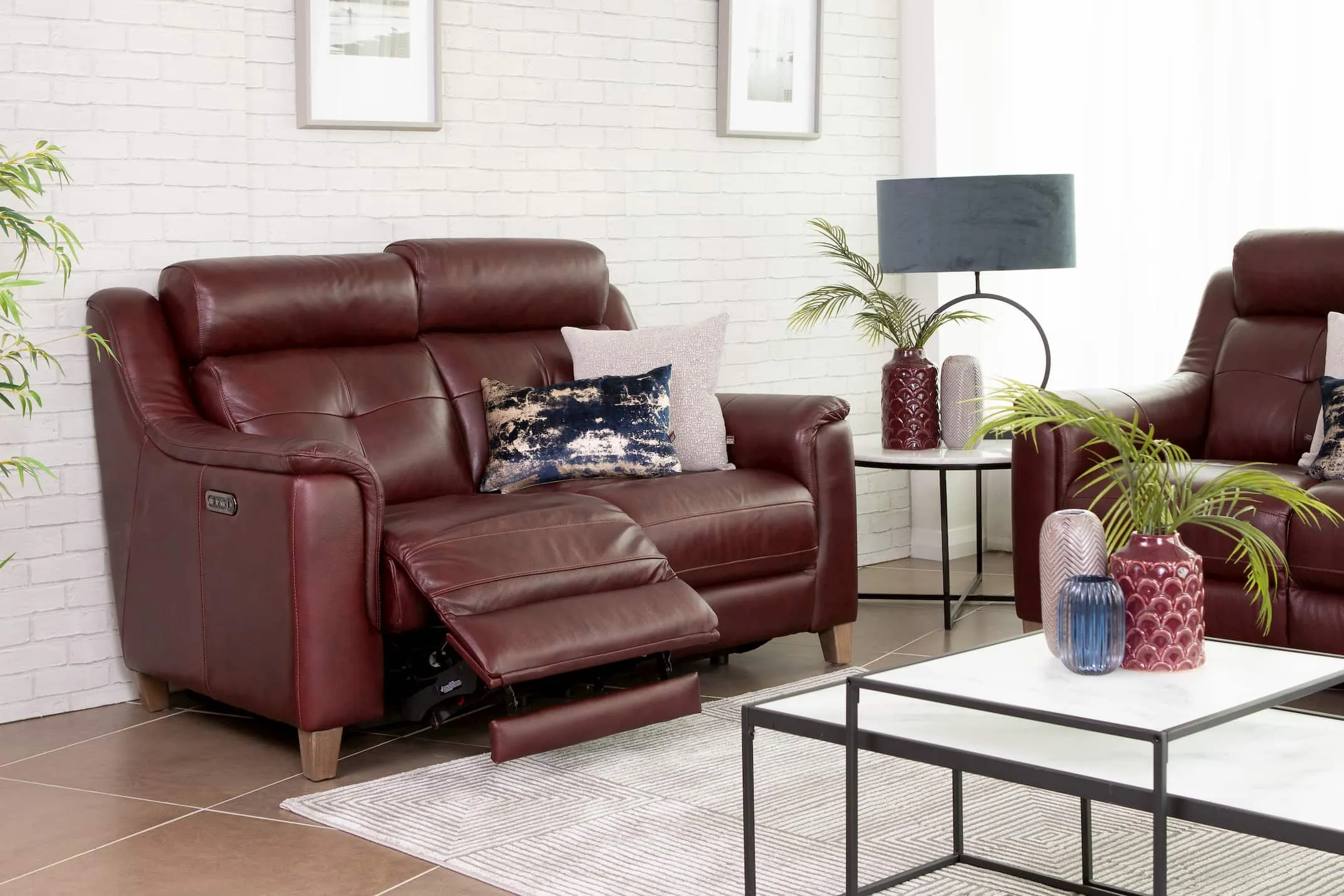 A lifestyle image of the Vantage Red 2 Seater with 3 seater & bolton tables.