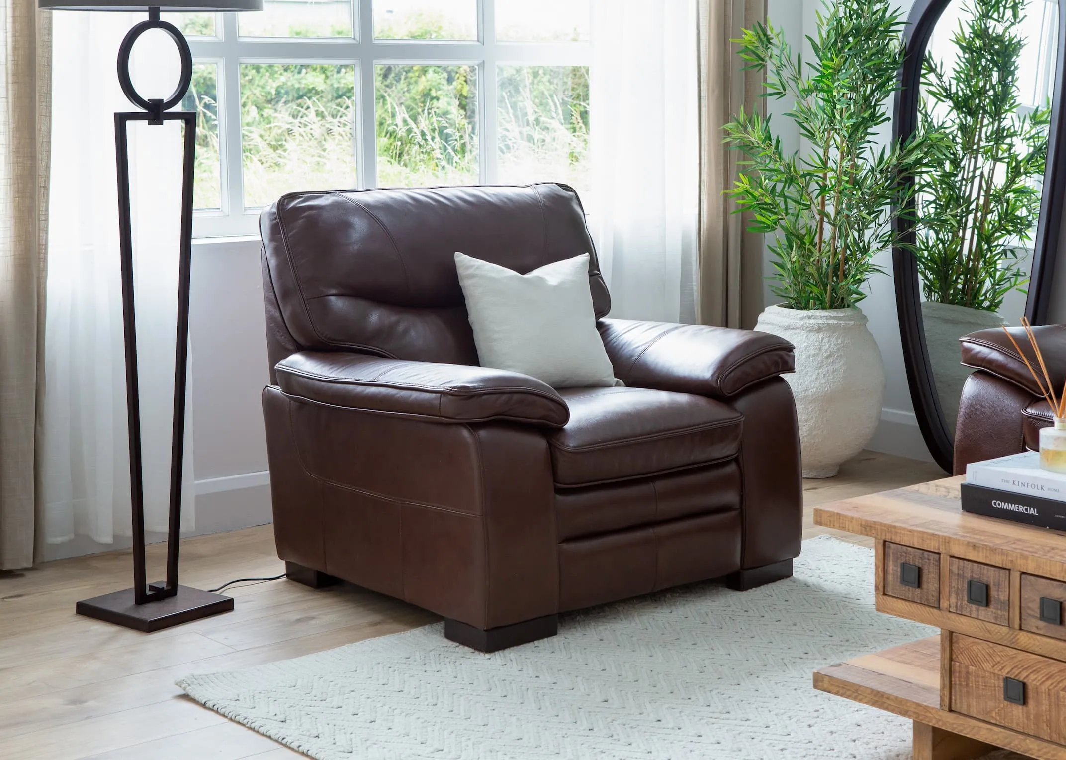 A lifestyle image of the Apollo armchair with Polygon coffee table & lucinda lamp