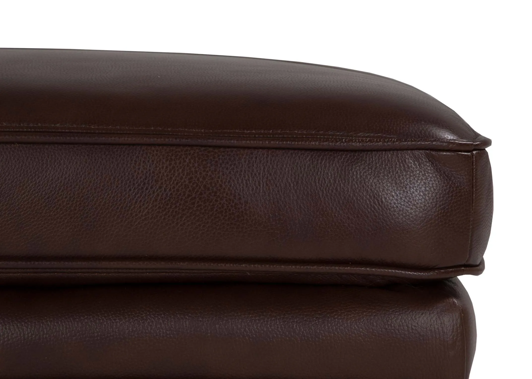 A close up image of the corner of the Apollo brown leather large footstool.