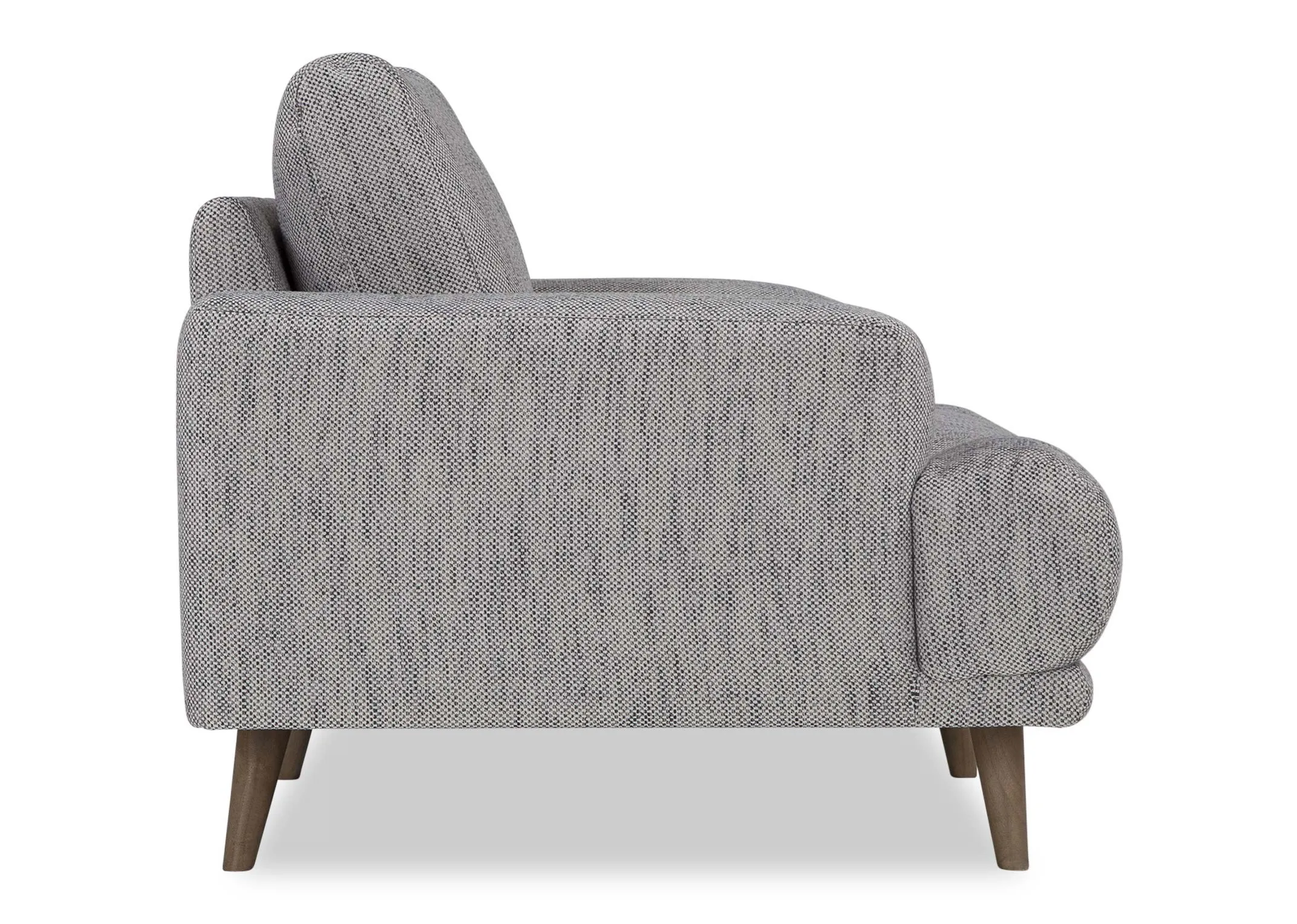 A view from the side looking at the Legend armchair in grey fabric.