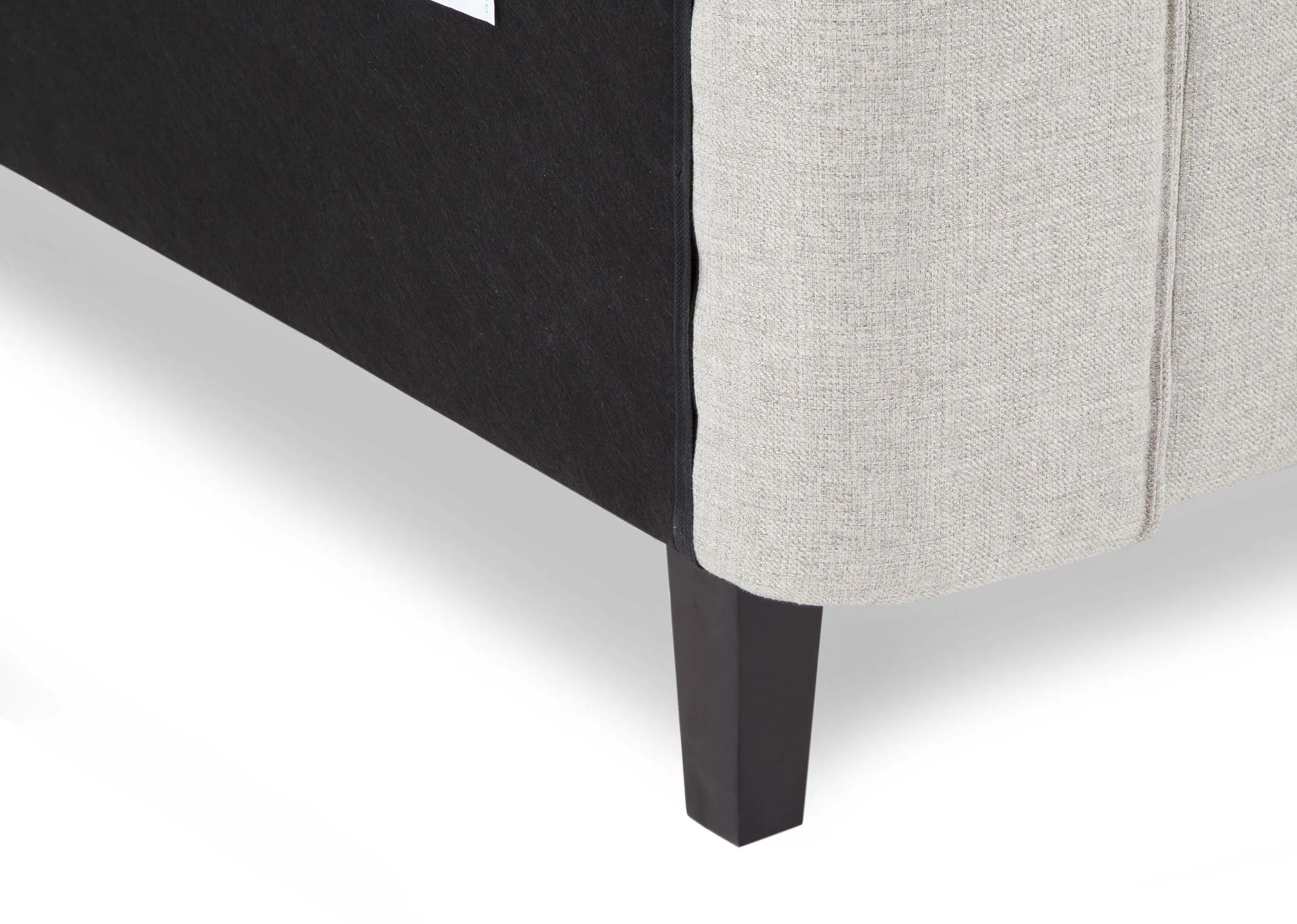 A close up view of the slats on the 6 ft beige fabric Chelsea armchair