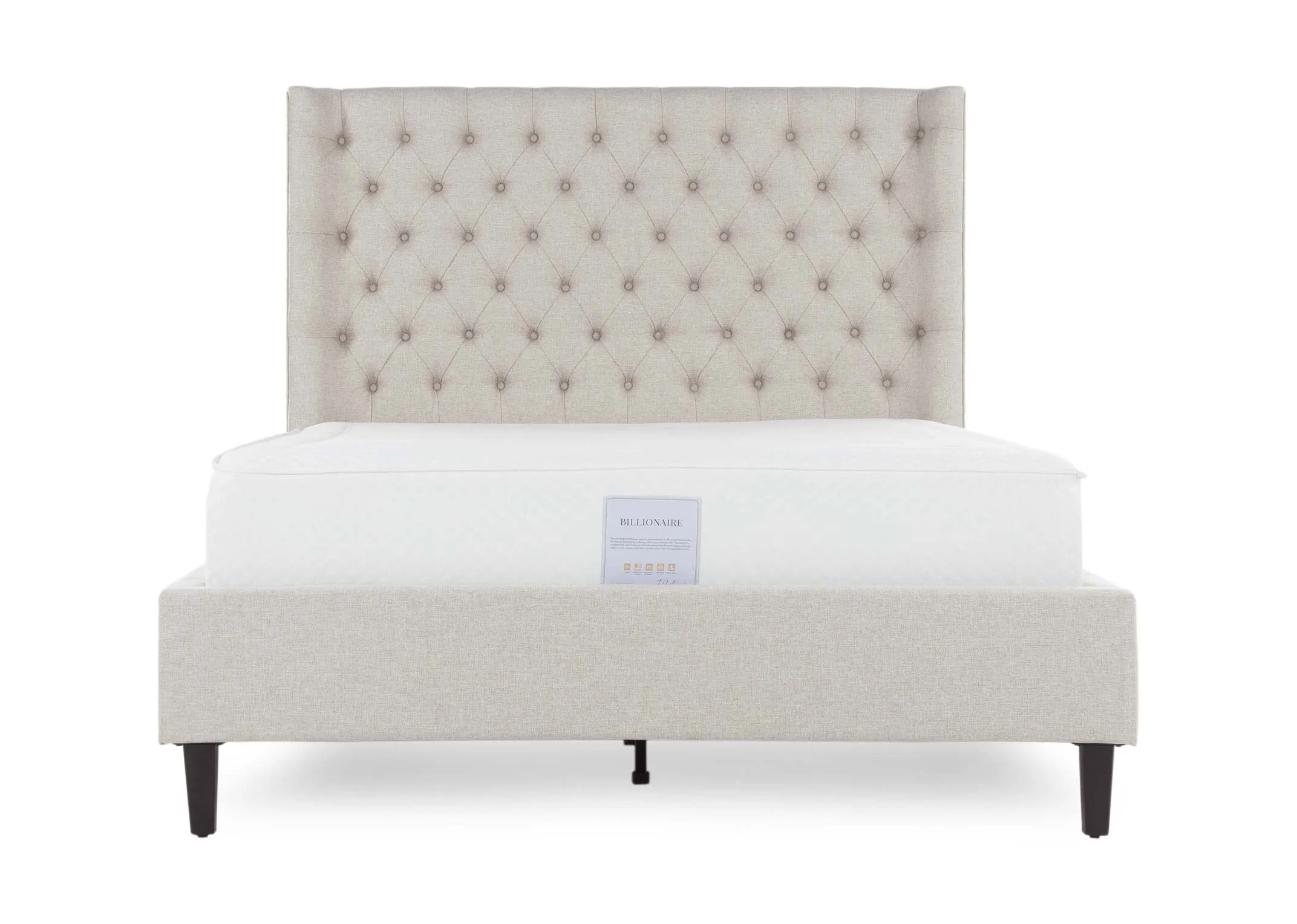 A close up view of the leg on the 6 ft beige fabric Chelsea bedframe