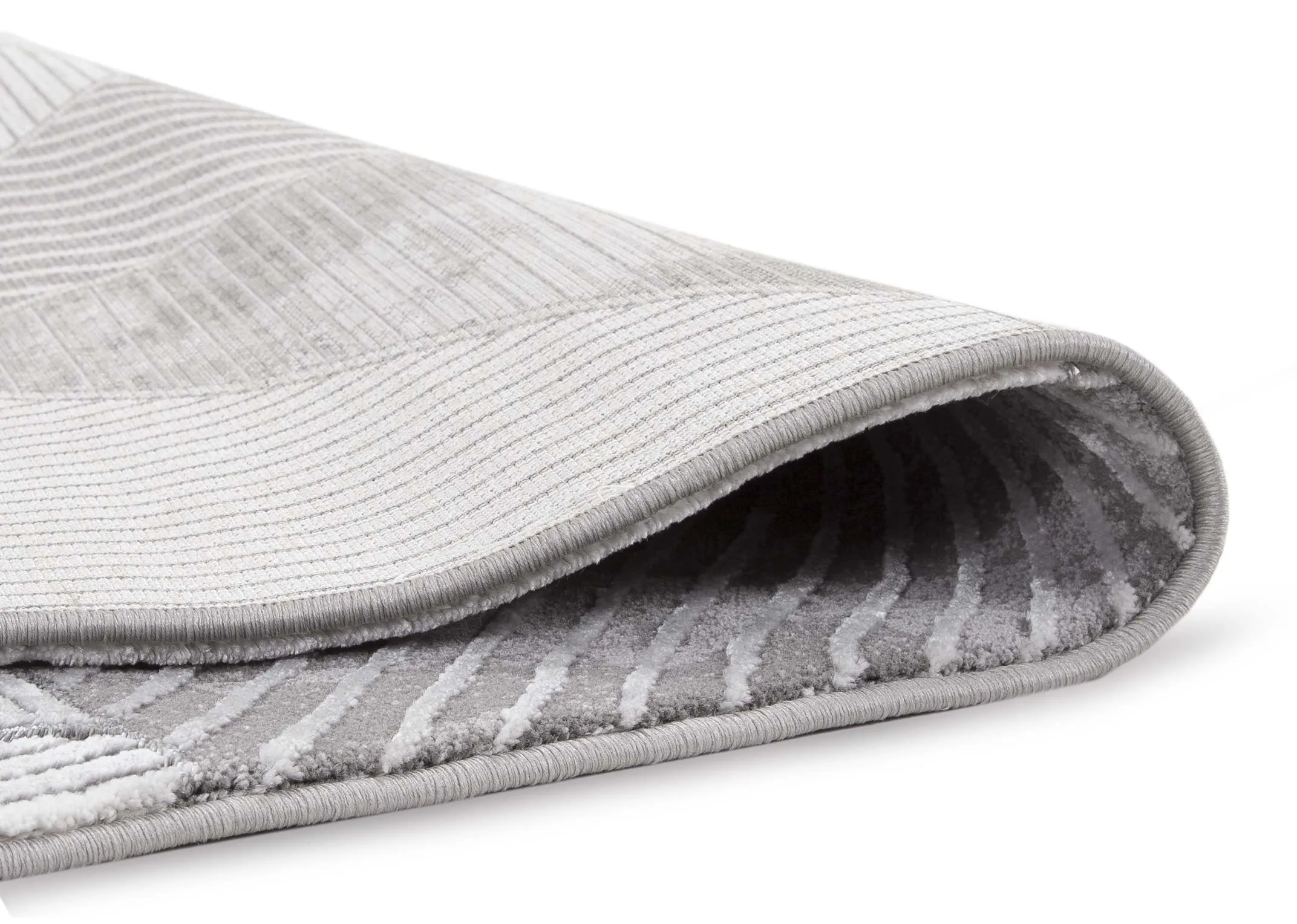 A close up view of the large geometric grey Dexter rug