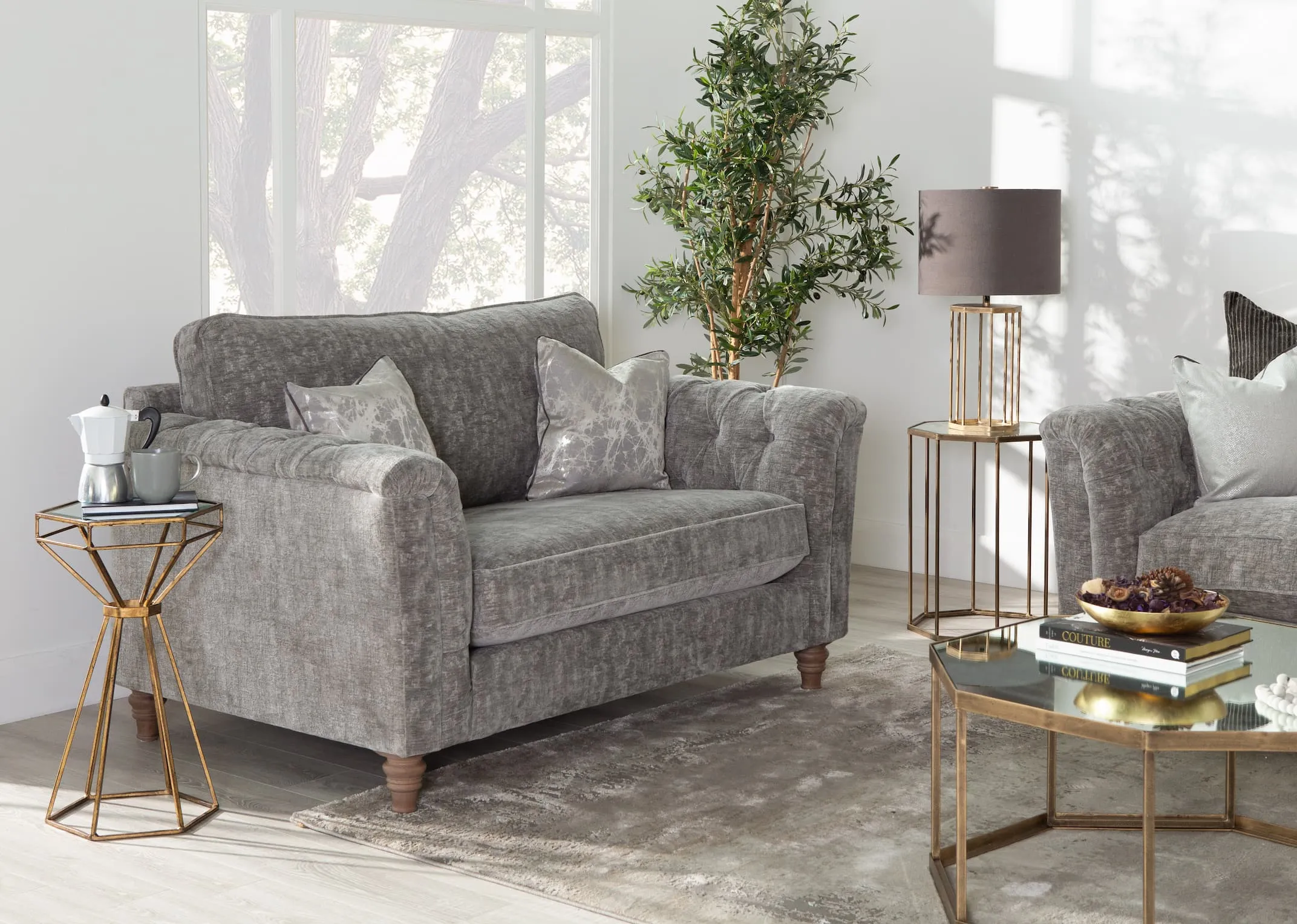 A lifestyle image of the Lottie Cuddler with hourglass table & Kylo rug.