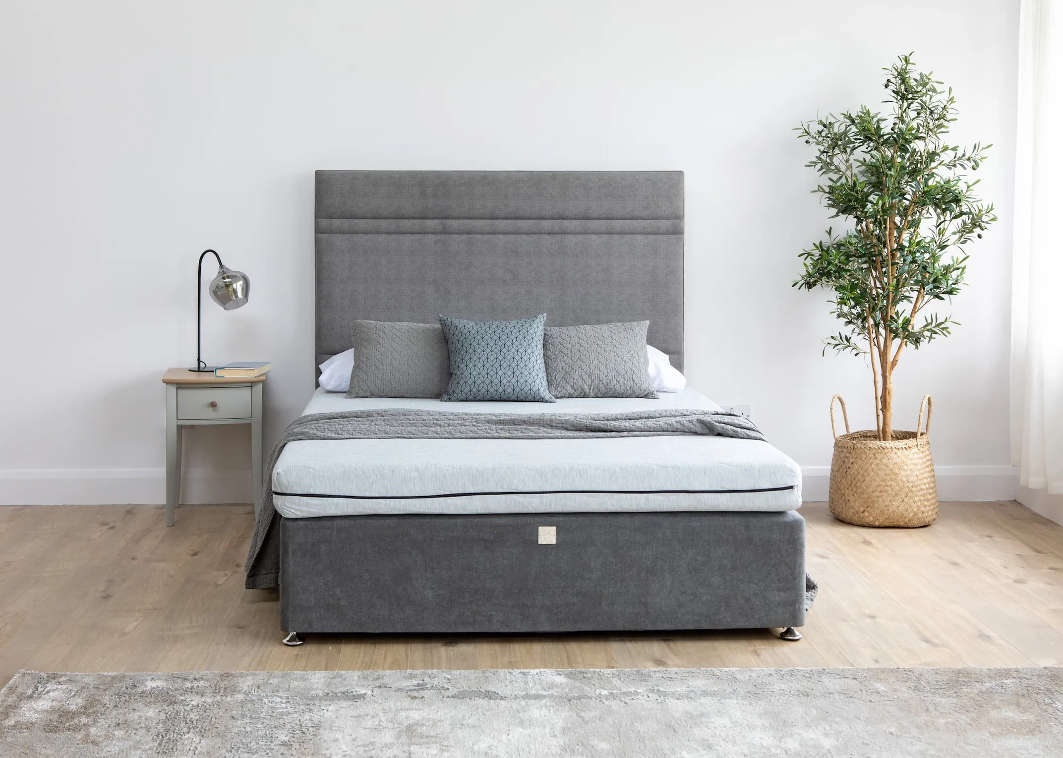 A lifestyle image of the Comfort Foam Mattress on a King Koil Divan bed with Whitby locker & rakel lamp.