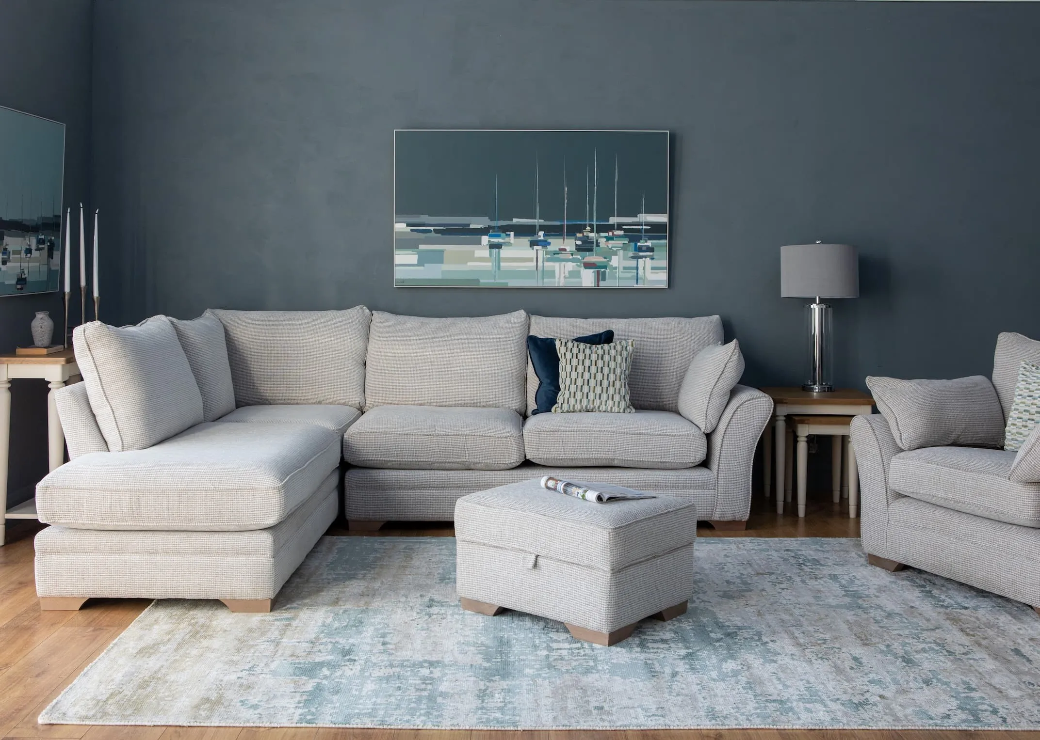 A lifestyle image of the Strata Corner Sofa with footstool & farmhouse tables