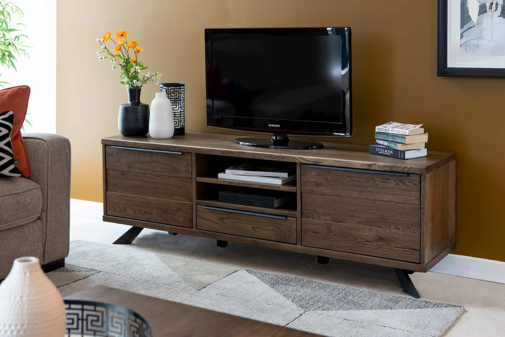 A lifestyle image of the Arno Smoked Oak TV Unit with the Darwin Sofa available at EZ Living Furniture.