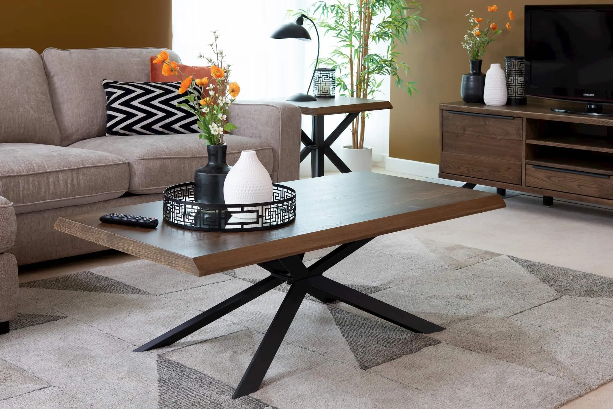 A lifestyle image of the Arno Smoked Oak Coffee Table with matching sideboard
