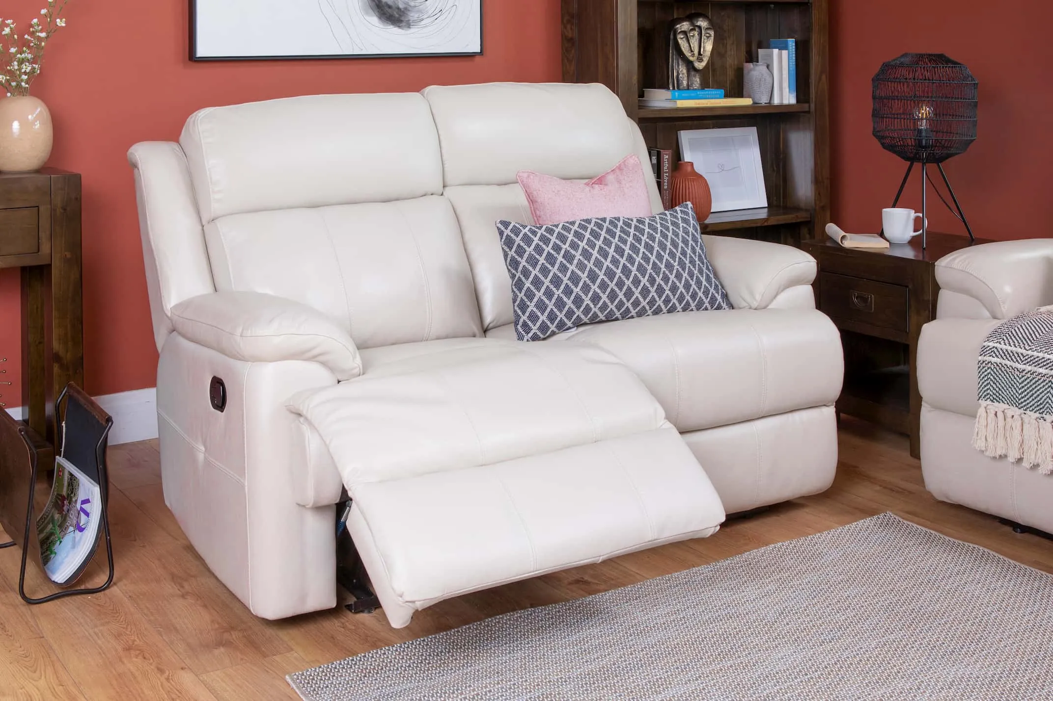 A lifestyle image of the Embrace 2 Seater Leather Recliner with Montreal bookcase