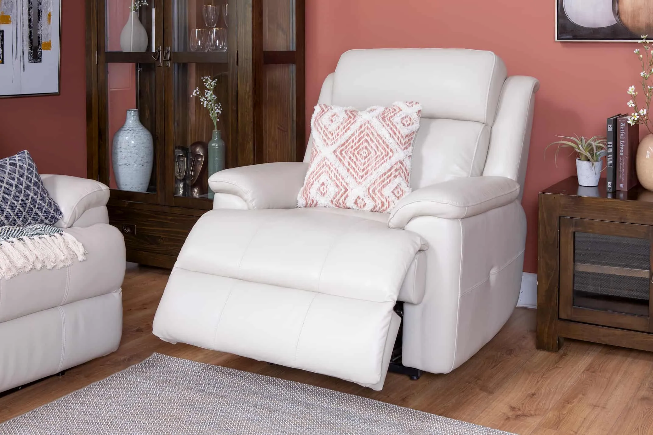 A lifestyle image of the Embrace Recliner in recline mode with Montreal display & tv unit