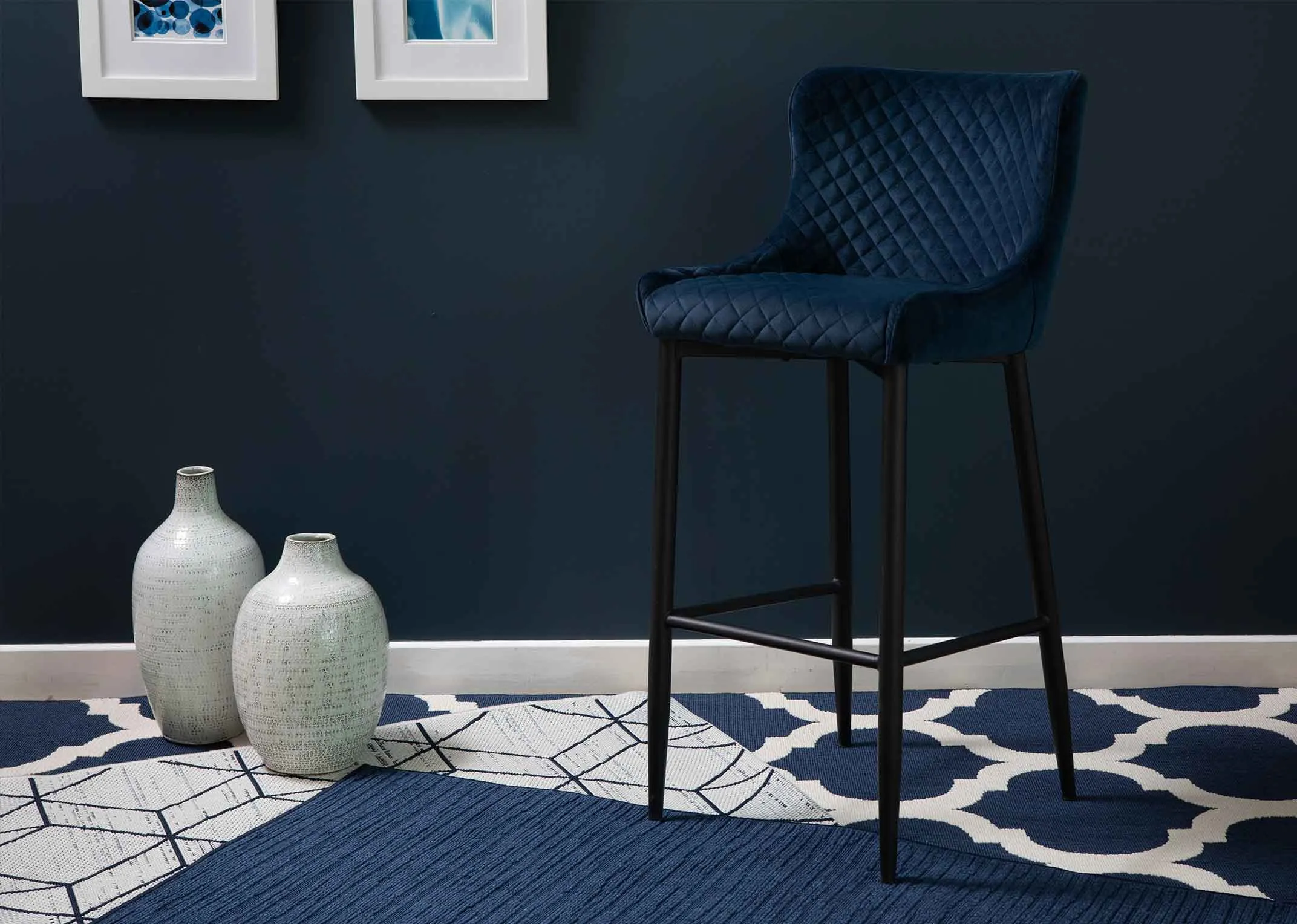 A plush blue velvet counter bar stool with black metal legs from EZ Living Furniture's Ottowa range. Closeup Seat.