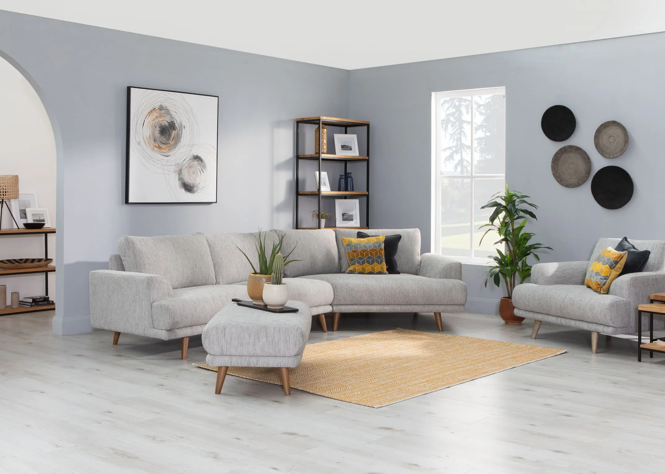 A lifestyle image of the Legend Corner Group with Footstool & Circles canvas & mila furniture