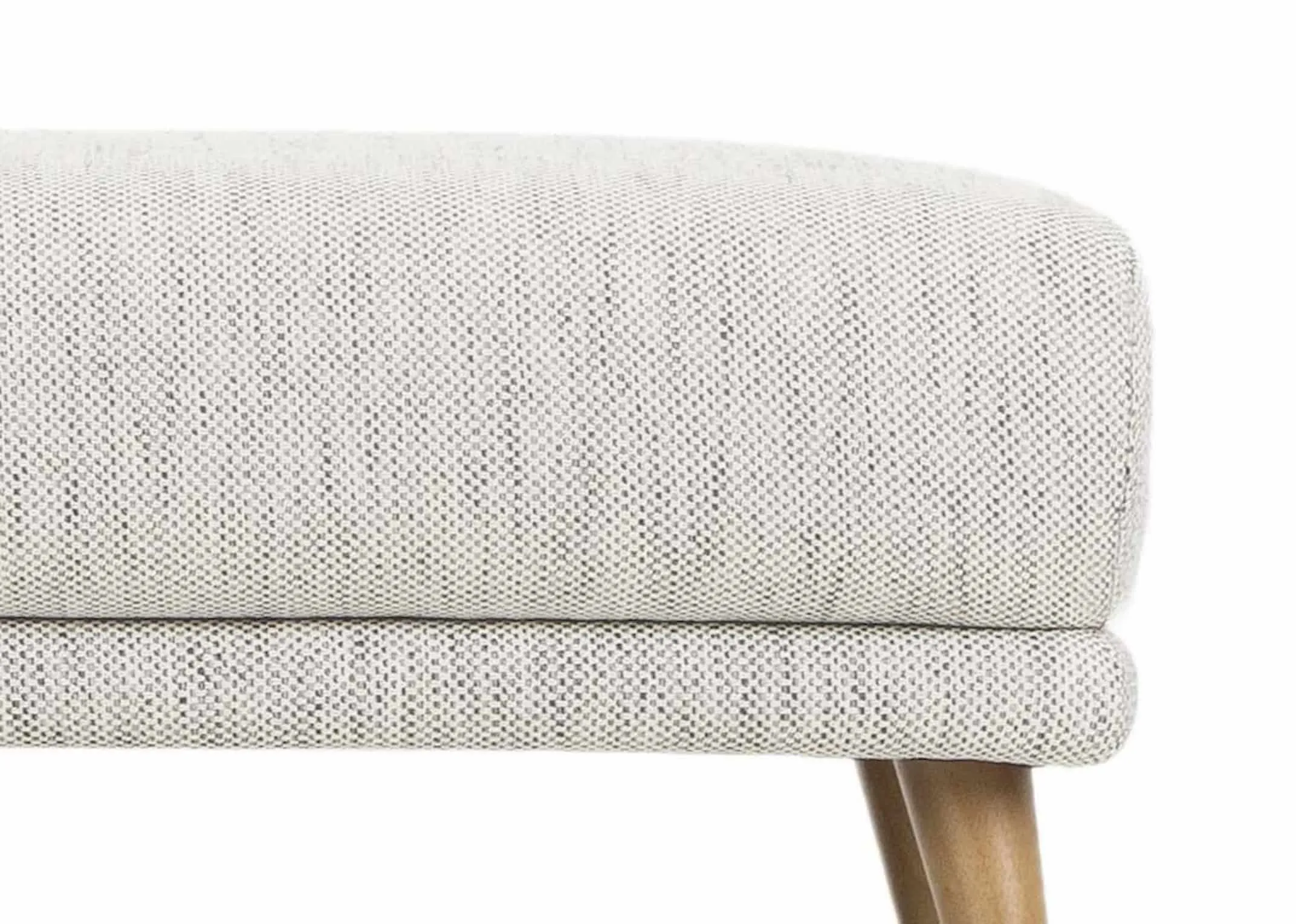 A light grey accent fabric footstool with light wood feet from EZ Living Furniture's Legend Range. Closeup of fabric & leg