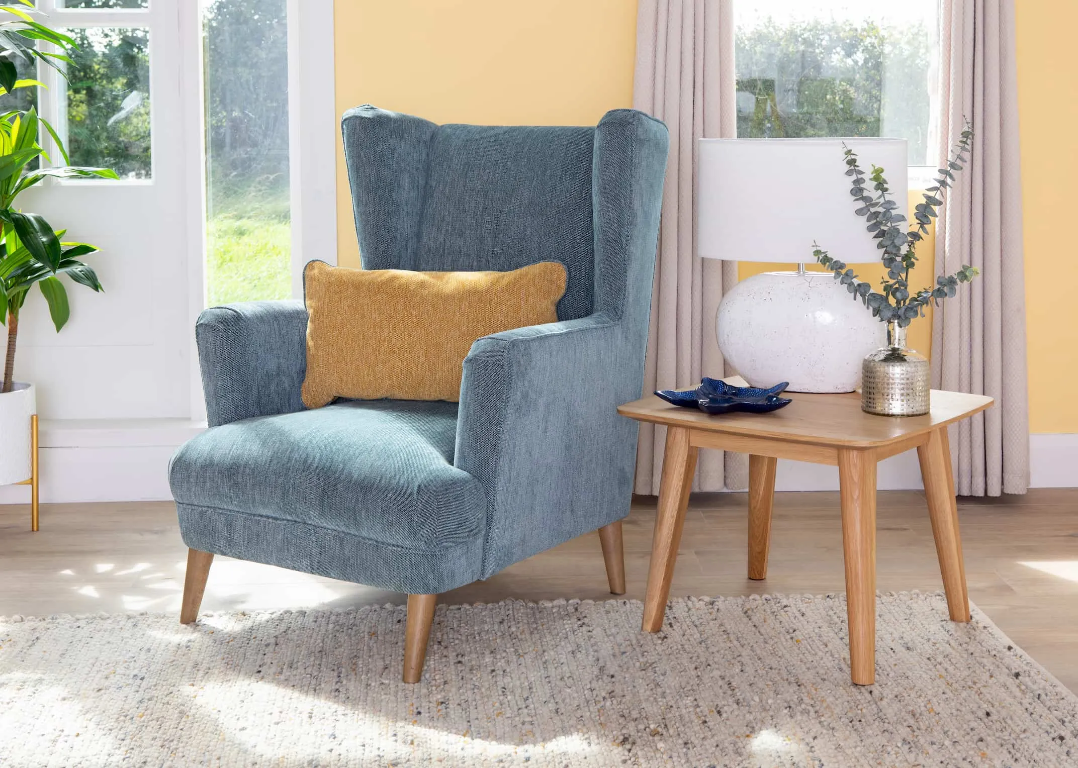 A lifestyle image of the Corrib Lamp on Rho table with the Relax Armchair