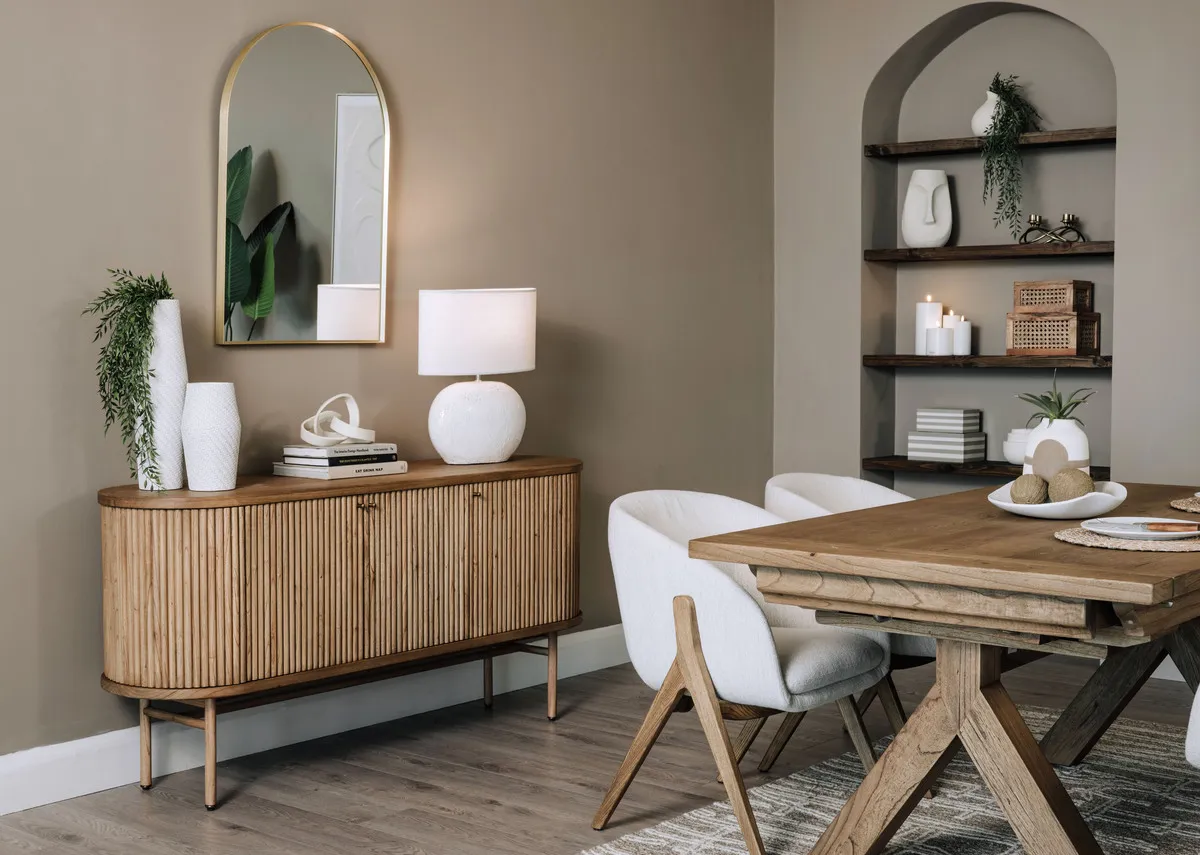 A lifestyle image of the Toulon sideboard with table and Flynn mirror with Corrib lamp.
