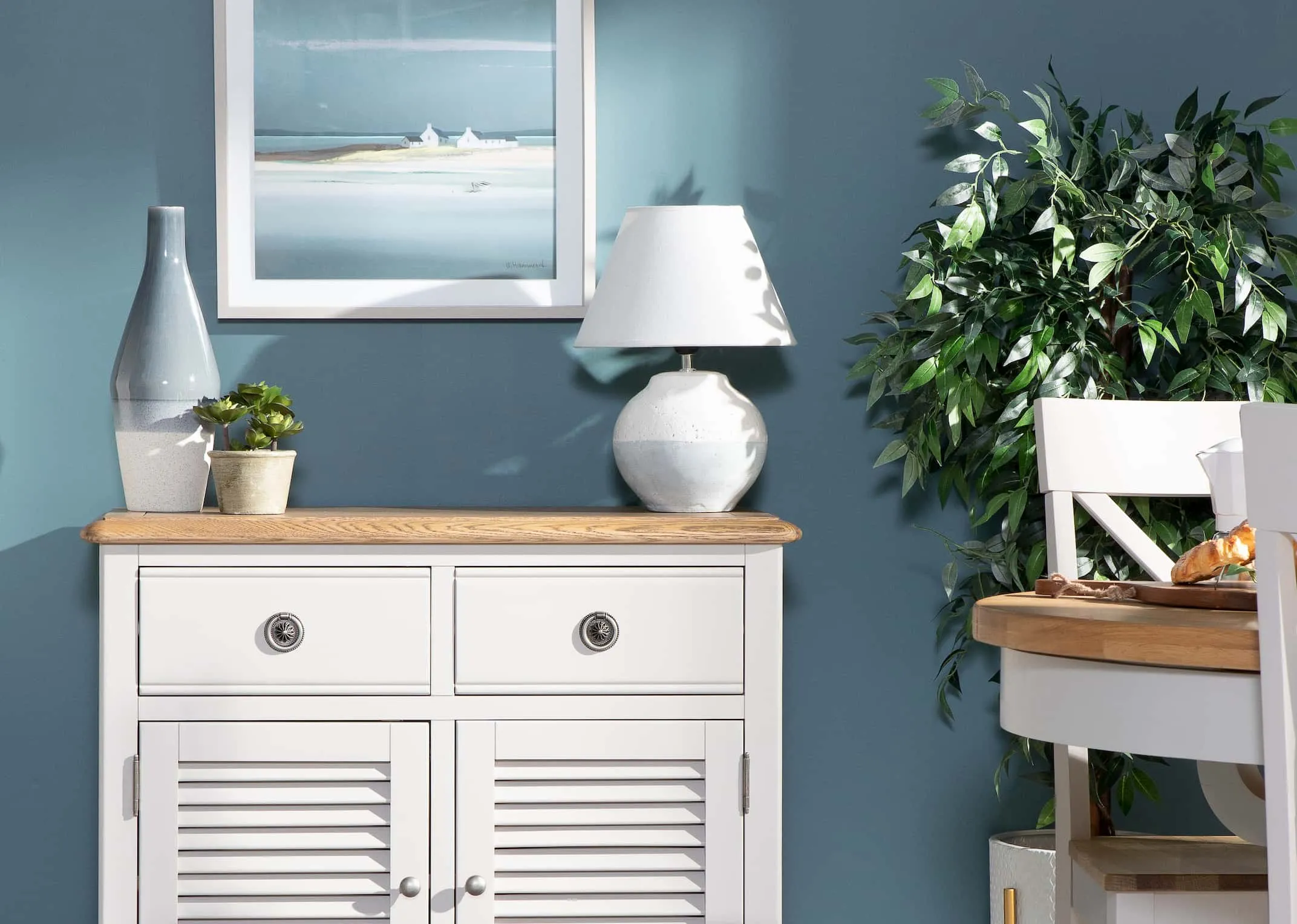 A lifestyle image of the Boyne Lamp with Toulouse Light Grey Dining Range.