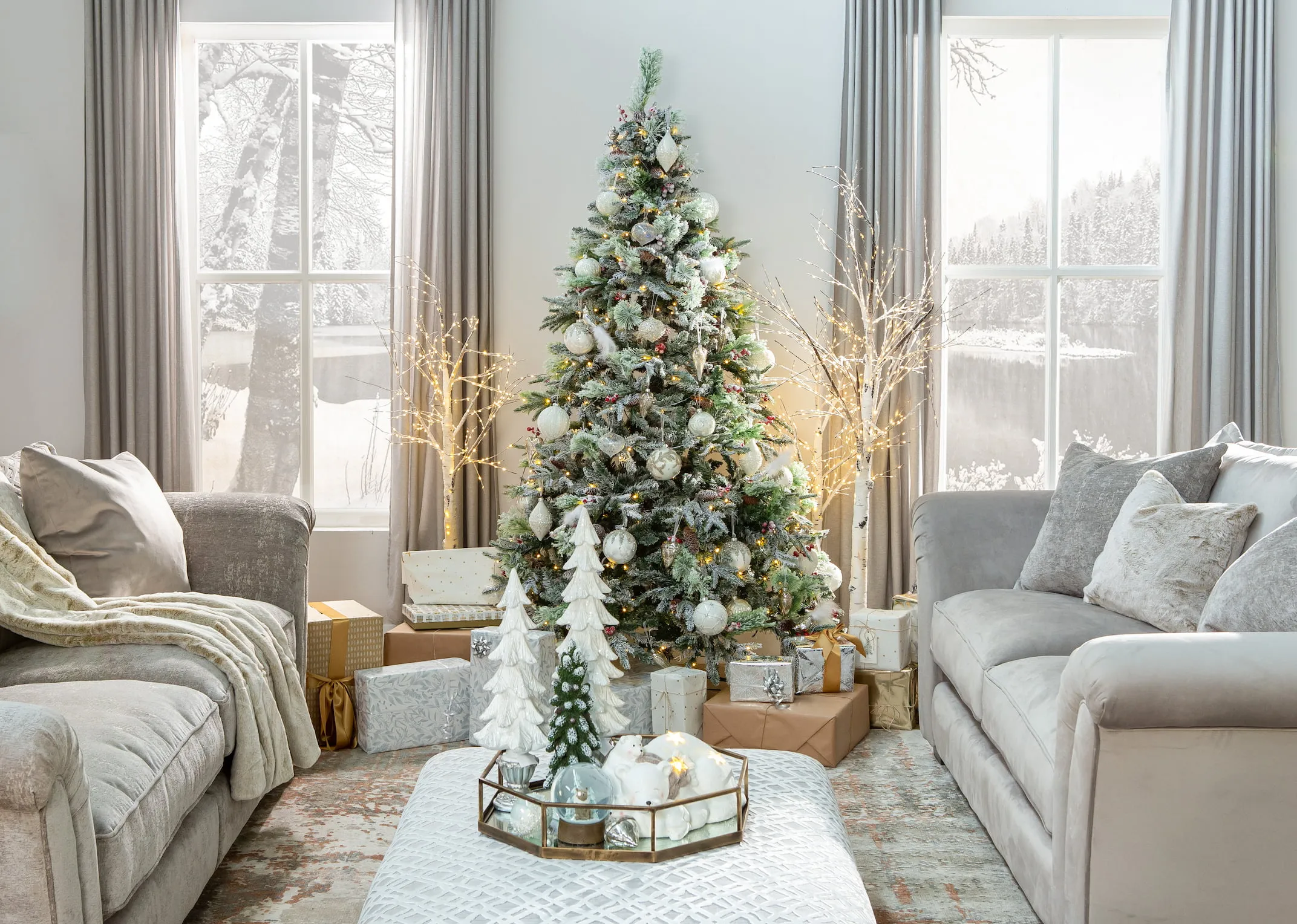 A lifetsyle image of the 2 size Birch trees with the Vermont white tree & tabitha sofas in a christmas wonderland setting