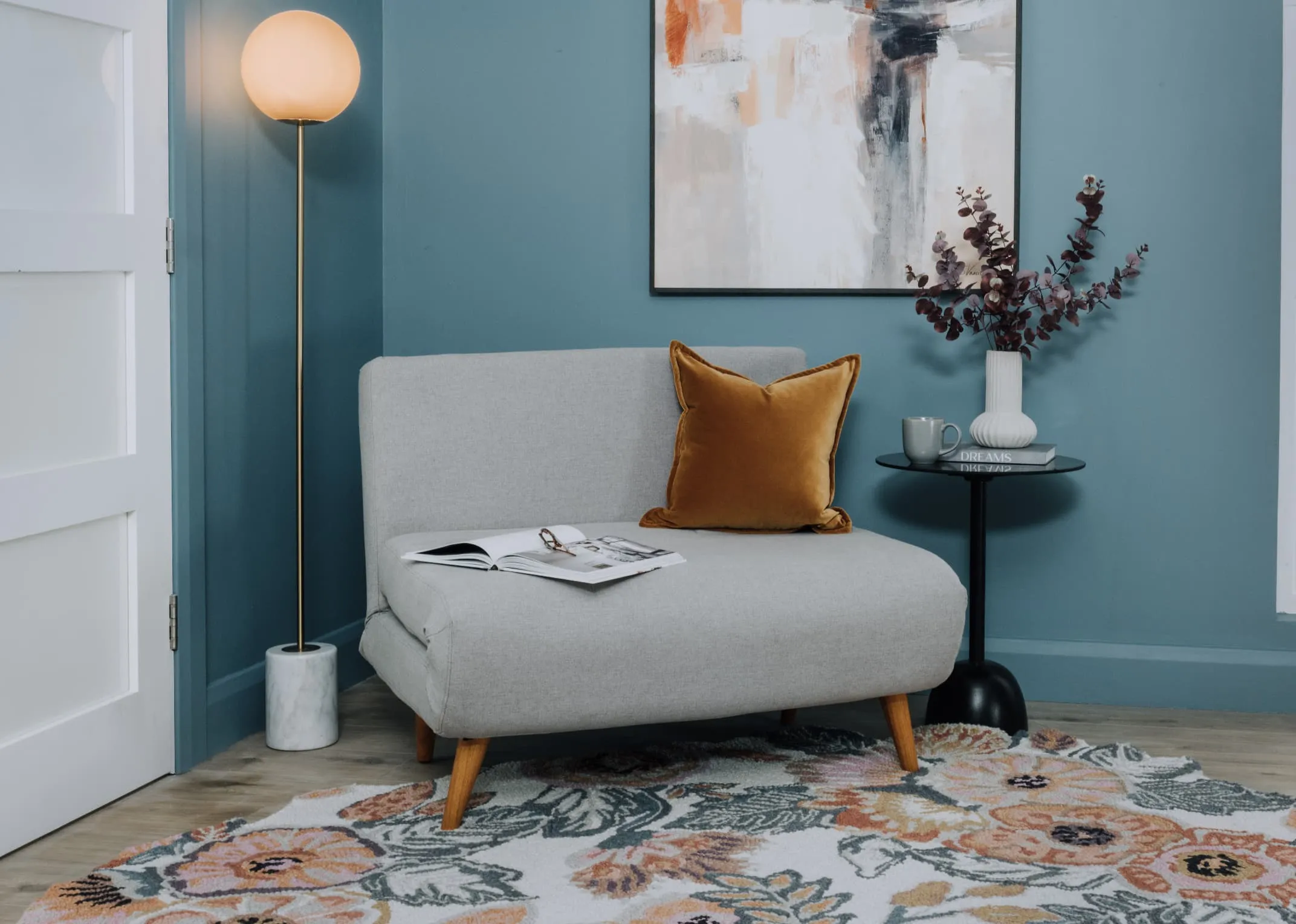 A lifestyle image of the Zara Grey sofa bed as a single sofa with the Barison rug.