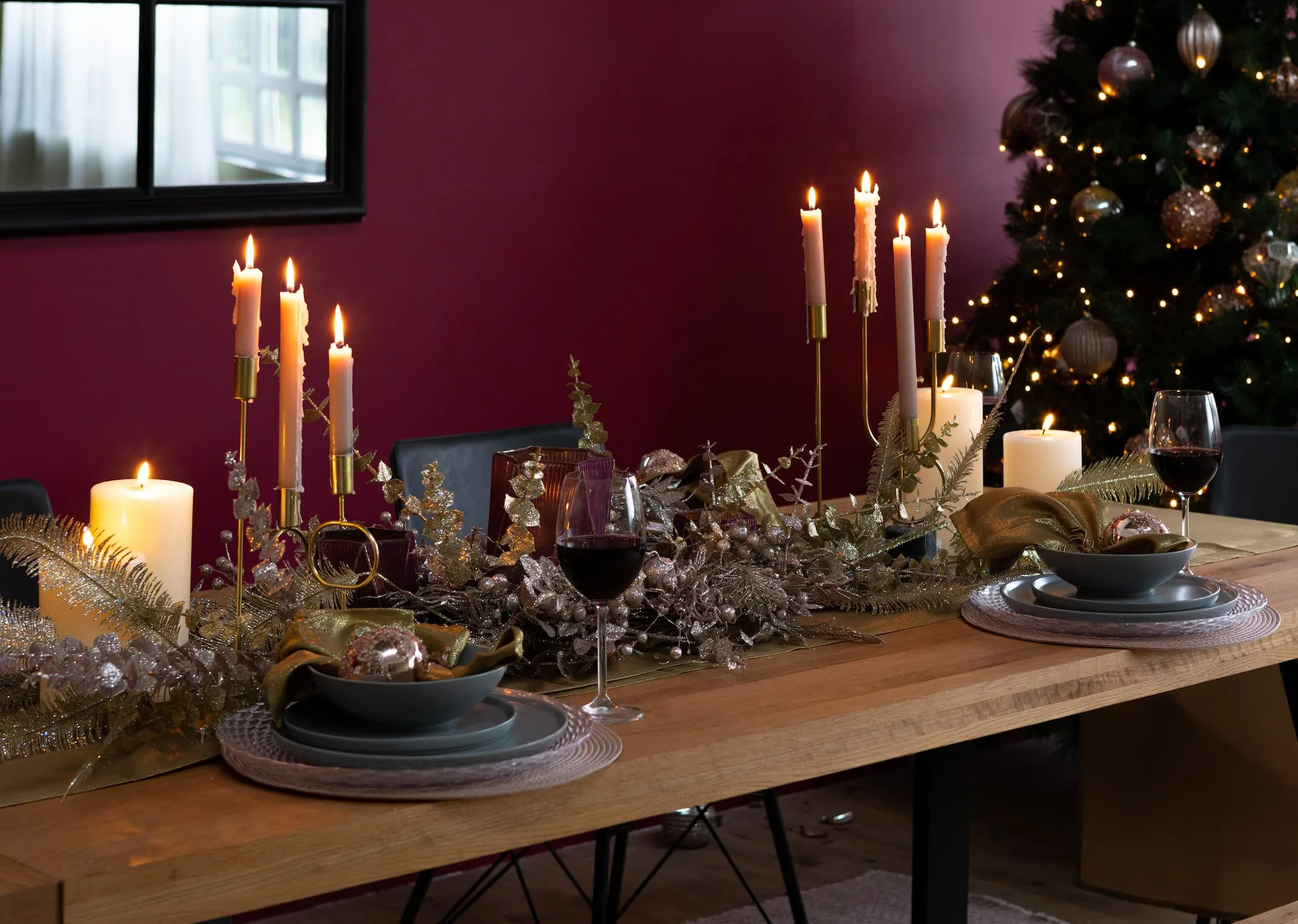 A lifestyle image of the Renvyle dining table with a selection of Christmas picks & candles displayed inc the champagne pick.