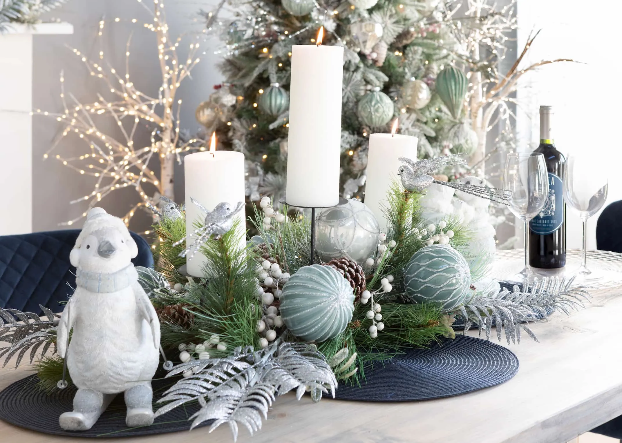 A lifestyle image of Pearl & Pine Candle holder with Glitter bird & blue decor