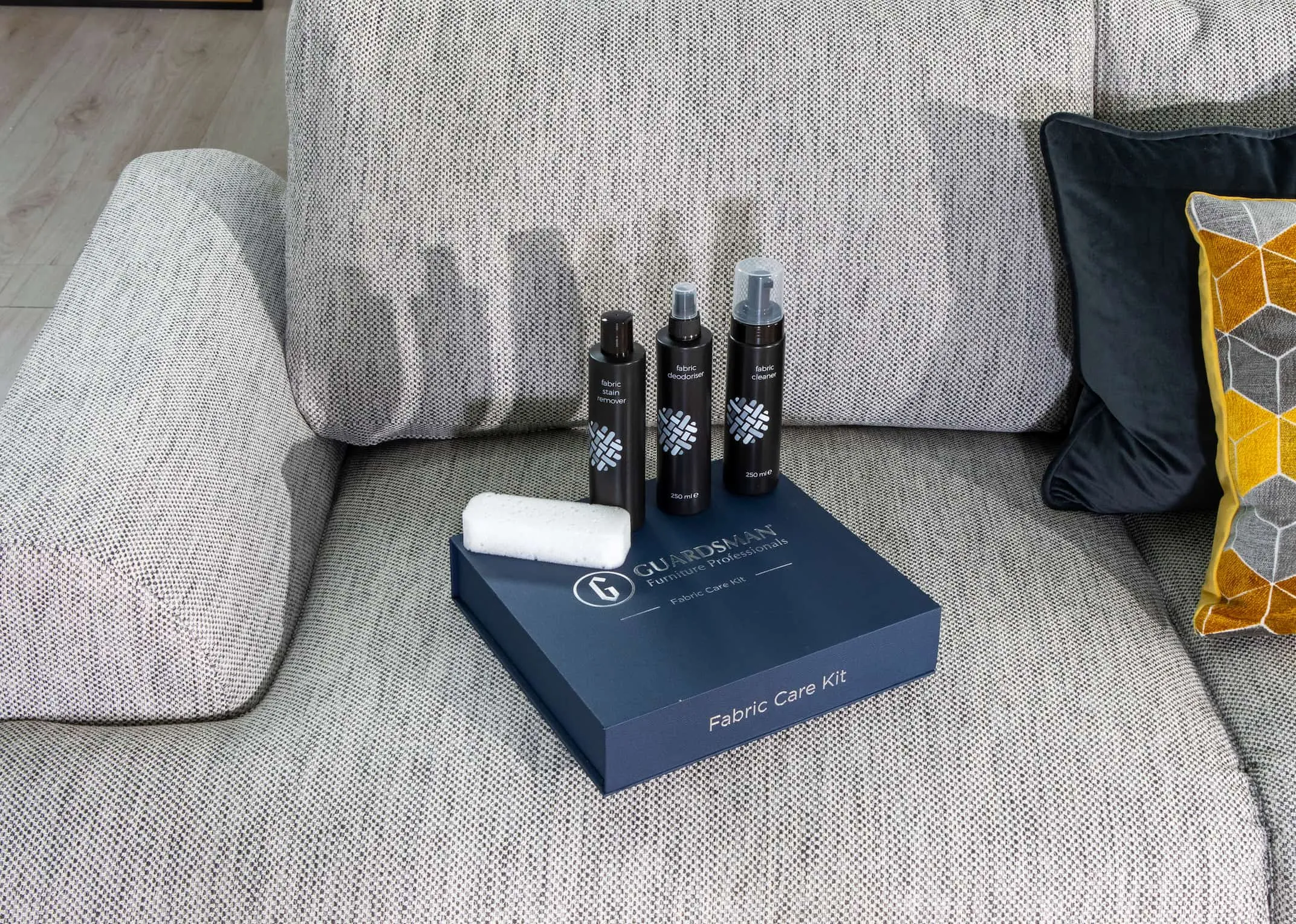 A lifestyle image of the Premium Fabric Care Kit with the Legend Sofa