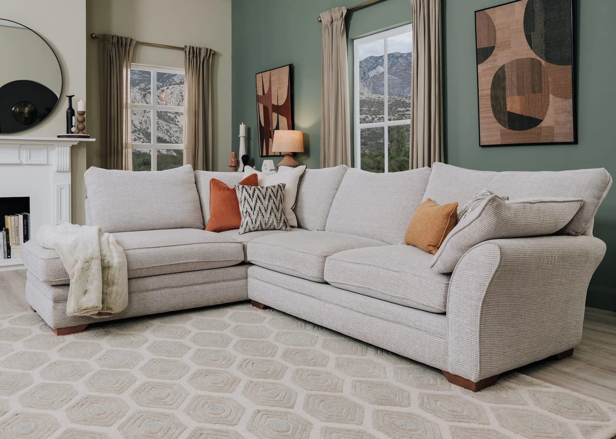 A lifestyle image of the Strata LAF chaise with a selection of velvet cushions and zene rung.