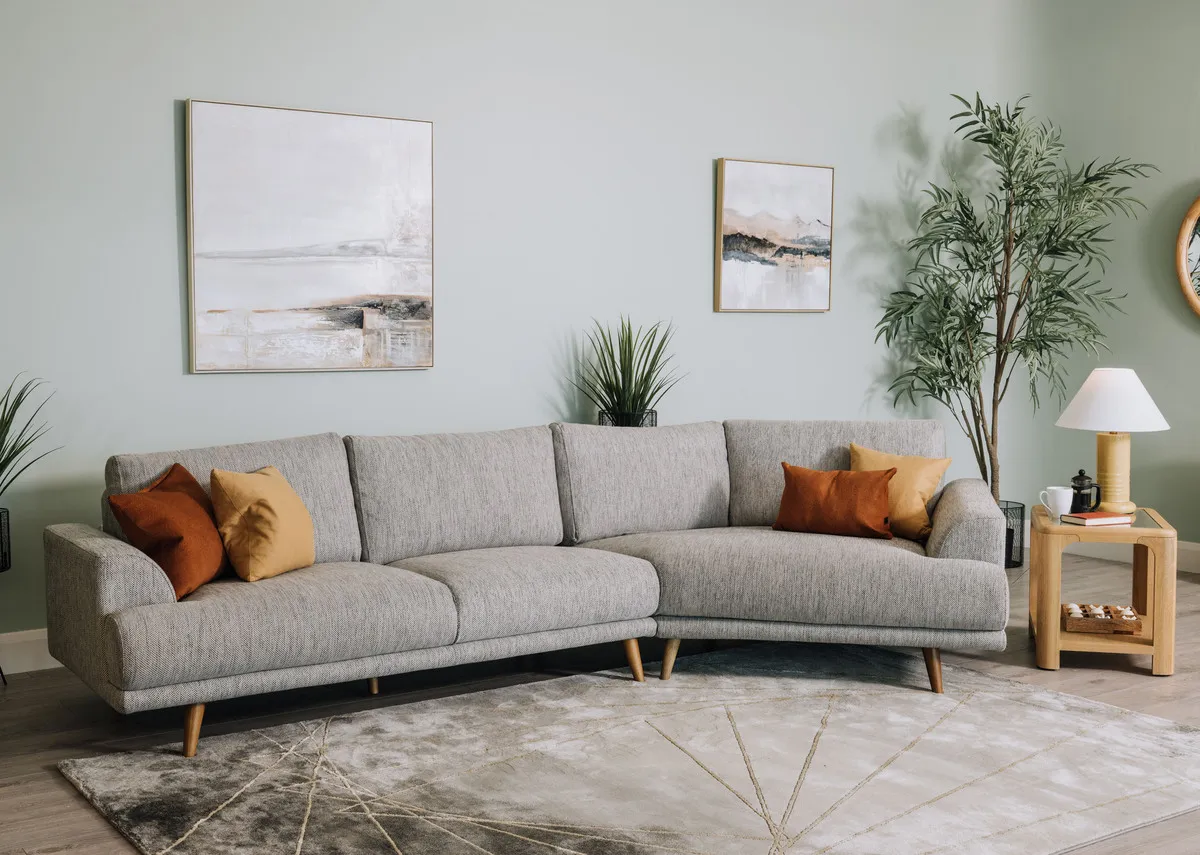 A lifestyle image of the Legend Corner sofa with Gus table and Althea lamp
