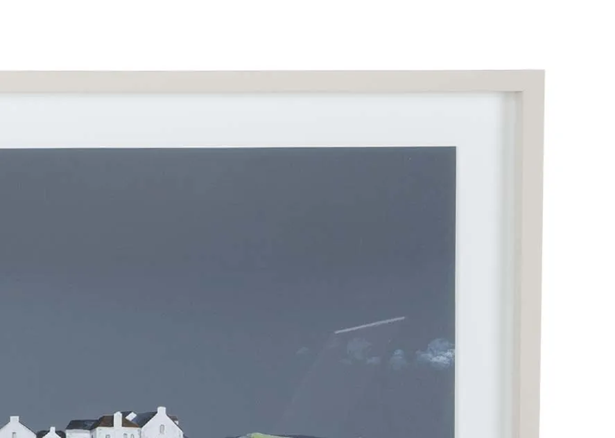 A white framed print of a house on the coast from Ulyana Hammond's True Blue range. Closeup of frame