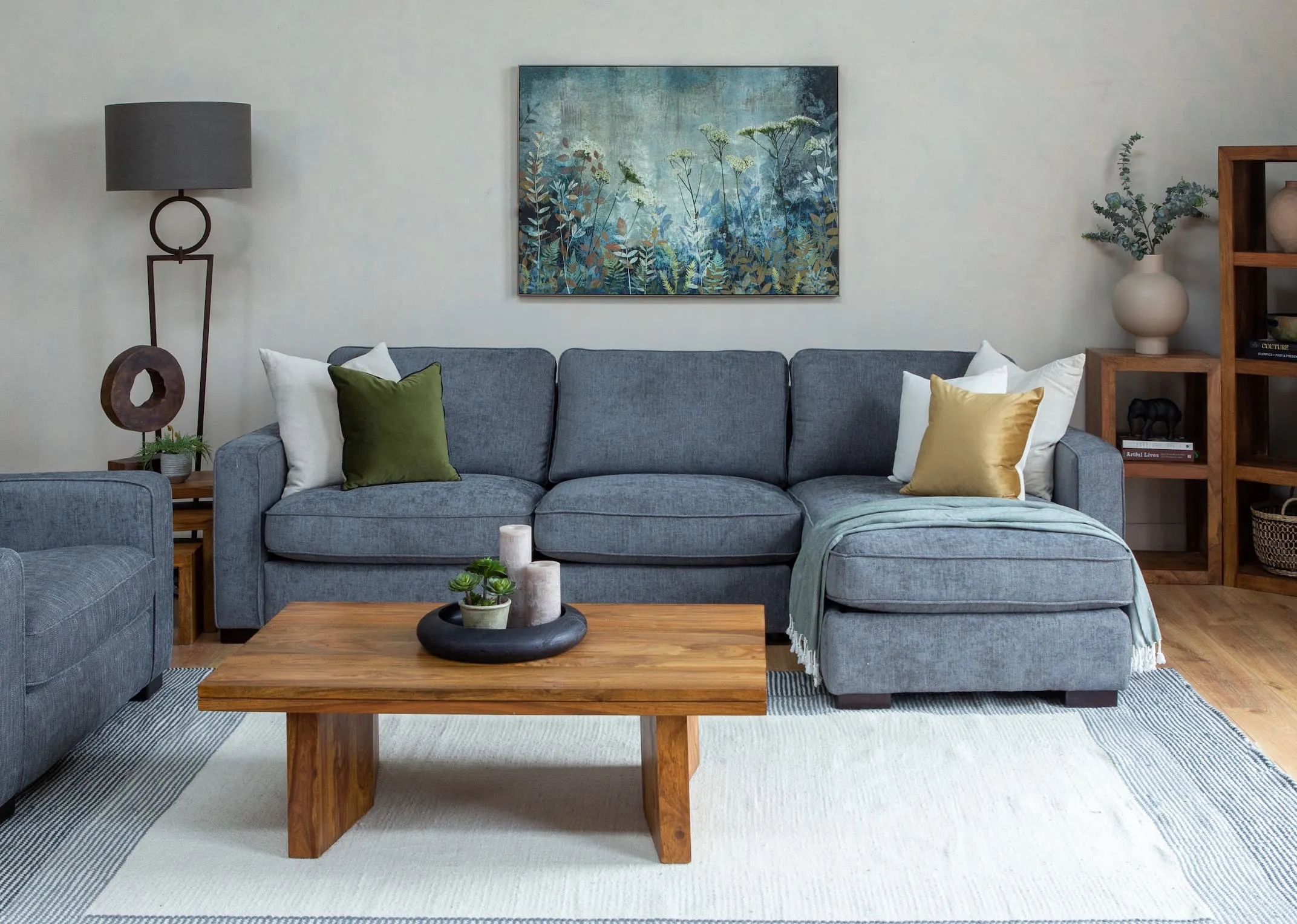 A lifestyle image of the Fanciful Canvas over the Darwin corner with India coffee table and display units
