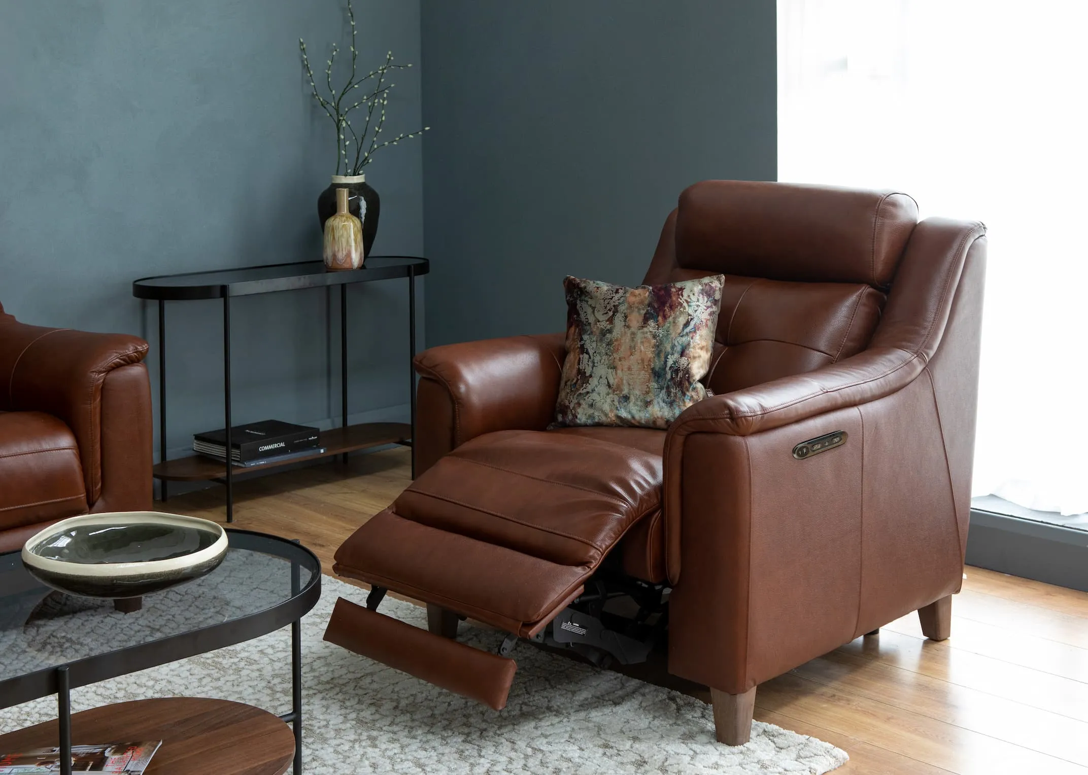 A lifestyle image of the Vantage Brown power recliner with glam furniture & time keeper print with Bolcho Lamp.