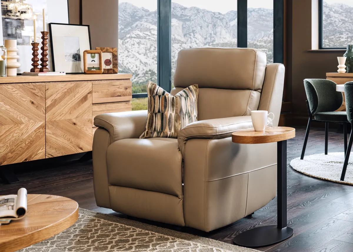 A lifestyle image of the Raven beige recliner with Ellipse sofa table