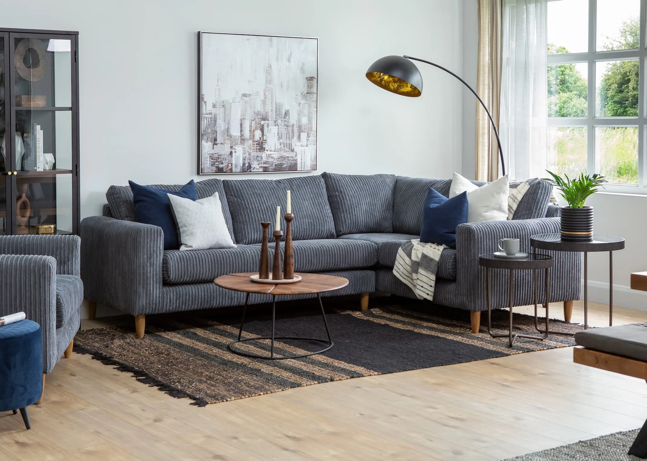 A lifestyle image of the Comfy Corner Sofa with shard tables and vagium rug.