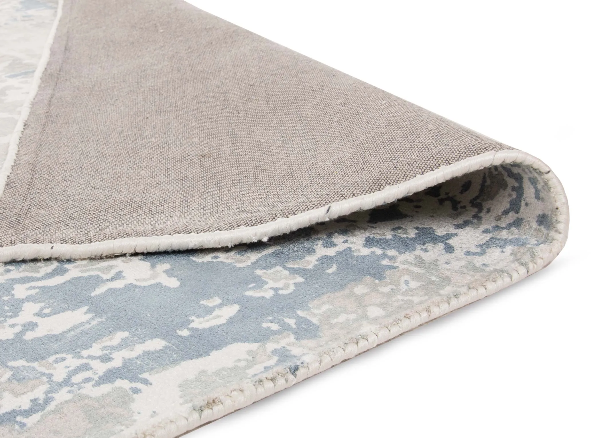 A blue & silver distressed medium rug from EZ Living's Moderno range. Angled view of the rug