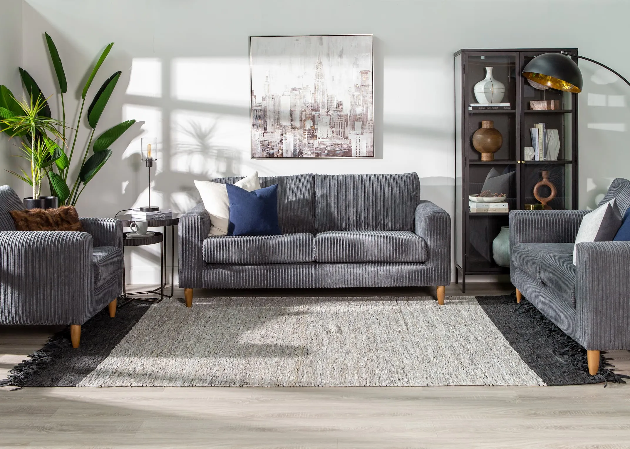 A light grey small woven rug with black trim & fringe from EZ Livings Vagium range. Front view with closeup window on woven fabric