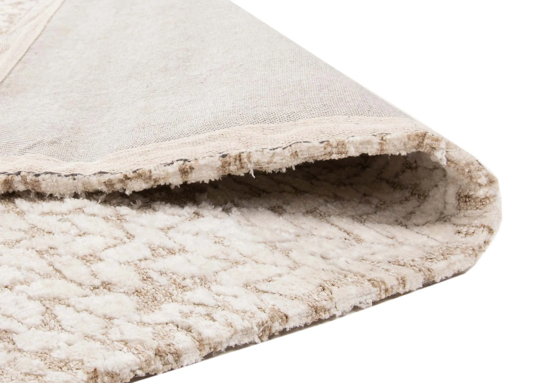 A large ivory & taupe textured rug from EZ Living Furniture's Milton range. Closeup of underlay & texture