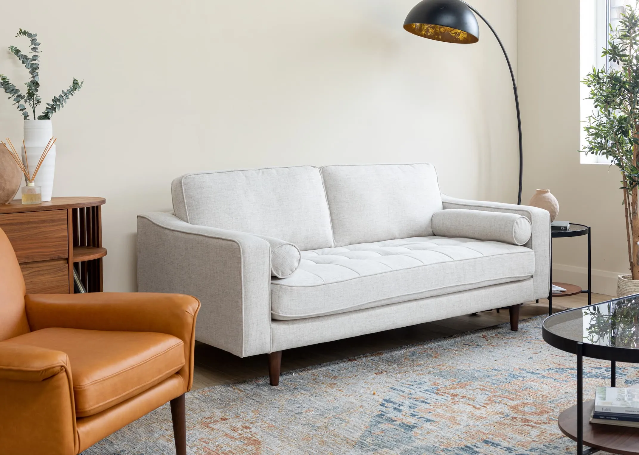 A lifestyle image of the Genoa Sofa & Donna Armchair with Cody mirror & maxima rug