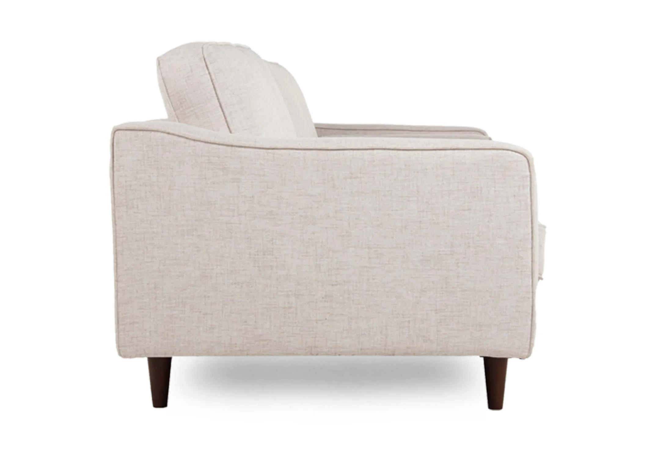 A cream fabric armchair with dark legs from EZ Living Furniture's Genoa range. Side view